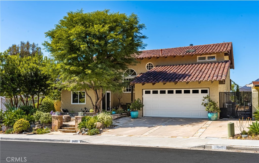 A truly one-of-a-kind custom residence nestled on a cul-de-sac in the hills of Mission Viejo, offering nearly 3,000 sq ft of thoughtfully upgraded living space with breathtaking panoramic views. This 4-bedroom, 3.5-bath with a primary bedroom downstairs with a murphy bed, this home blends timeless design with modern luxury, featuring real oak wood floors, vaulted Douglas fir ceilings, custom interior doors and hardware, and oversized bedrooms including two custom walk-in closets and a Jack-and-Jill bathroom with dual sinks plus a bonus room. The gourmet chef’s kitchen showcases handcrafted cabinetry, high-end appliances, and a custom-designed wine bar and breakfast nook—perfectly tucked into a cozy corner, ideal for casual mornings or evening entertaining with friends. The kitchen flows effortlessly into spacious living and dining areas with natural light pouring through large windows and French doors. Comfort is elevated with dual-zone A/C systems (upstairs and down), brand-new carpet upstairs, and a host of thoughtful add-ons. Step outside to an entertainer’s dream yard with a new built-in BBQ, outdoor fridge, and drought-tolerant, low-maintenance landscaping, all set against serene hillside views. With a Spanish tile roof, full termite clearance, and included architectural plans, this home offers unmatched quality, privacy, and California living at its finest. Lake Mission Viejo Membership includes exclusive access to private beaches, boating, fishing, summer concerts, picnic areas, and a variety of seasonal community events, offering a resort-style experience year-round.