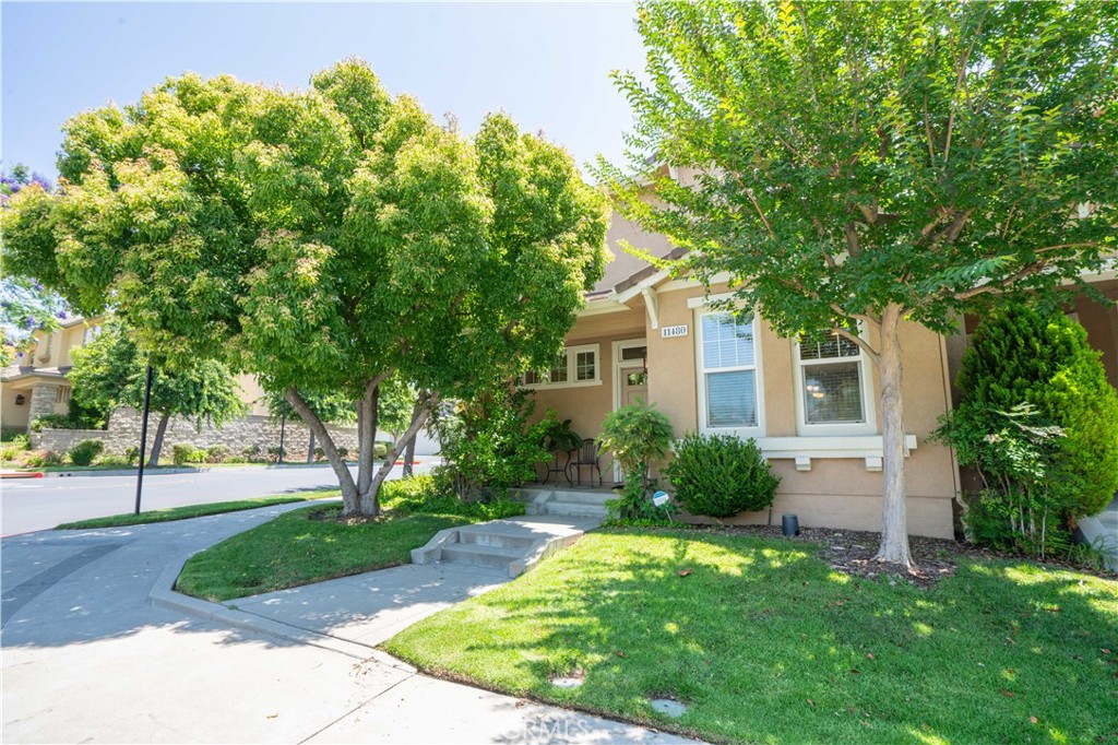 Picturesque in Promenade! Welcome to this stunning Plan 3 Arbor townhome, located in the prestigious, guard-gated community of Promenade at Porter Ranch. This beautifully maintained home offers comfort, functionality, and style in one of the area’s most sought-after neighborhoods. Step inside to discover a spacious cook’s kitchen featuring a breakfast bar, cozy breakfast nook, tile countertops, ample cabinetry, and more—perfect for everyday living and entertaining. The open-concept layout continues with a warm and inviting living room and an elegant dining area, ideal for family dinners, holiday gatherings, or casual get-togethers. A highly desirable main-floor bedroom and full bathroom provide flexibility for guests, multigenerational living, or a home office. Upstairs, retreat to a generously sized primary suite complete with a large walk-in closet, dual vanities, a separate shower, and a luxurious soaking tub. You’ll also find a built-in desk nook—ideal for working from home or a student study area—and a conveniently located laundry room on the same level. Step outside to your private patio oasis, complete with a built-in BBQ—just in time for summer entertaining! Located on a prime corner lot, this home is just steps away from the sparkling community pool and BBQ area, providing a true resort-style lifestyle. Additional highlights include an attached two-car garage with a 220 outlet for possible EV charging, and the highly rated Porter Ranch Community School K–8 district (per LAUSD website; buyer to independently verify district & enrollment availability).Enjoy unmatched convenience with The Vineyards at Porter Ranch just minutes away, offering upscale shopping, dining, Whole Foods Market with in-store restaurant, Nordstrom Rack, state-of-the-art AMC Theatres, fitness centers, and more. Don’t miss this incredible opportunity to own a beautifully appointed home in one of Porter Ranch’s most coveted gated communities!