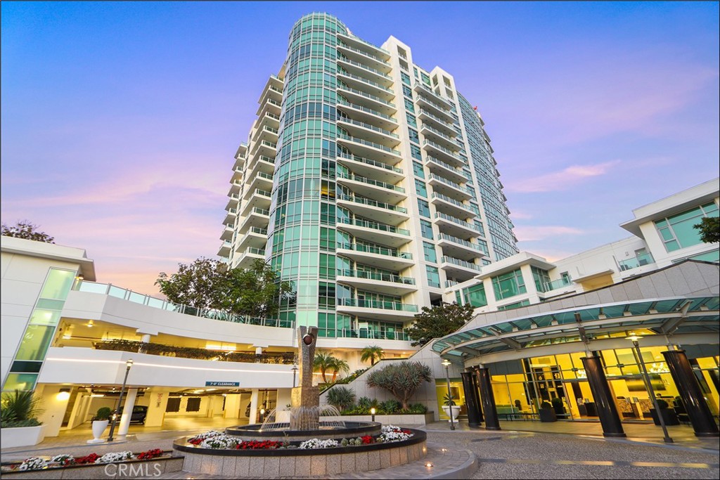 SOPHISTICATED HIGH-RISE LIVING WITH PANORAMIC VIEWS AND TOTALLY REMODELED WITH BRAND NEW HIGH END UPGRADES THROUGHOUT! Perched on the 13th floor of Irvine’s coveted Marquee at Park Place, this residence blends modern design with resort-style amenities and breathtaking vistas. Floor-to-ceiling windows from this highly sought after corner unit frame sweeping city lights, mountain, and sunset views, bathing the interiors in natural light and creating an airy, open atmosphere. Inside, the expansive great room showcases designer style flooring and seamless flow to the dining area and a private balcony—perfect for sunset cocktails or morning coffee. The sleek chef’s kitchen features designer style Quartz countertops, high end Dacor stainless-steel appliances, and a generous breakfast bar, ideal for both entertaining and everyday living. The primary suite offers a tranquil retreat with a walk-in closet featuring closet organizers and spa-inspired bath featuring dual vanities, an an oversized walk-in shower with two shower heads, seats on both sides and all high end Kohler fixtures. Large second bedroom and full second bathroom with tub and shower which is also totally remodeled with high end Kohler fixtures. Amazing office/3rd room with spectacular views can also be den, study or third room for guests. Everyday luxury continues outside your door with 24-hour guard-gated entry and concierge service, resort-style pool and spa, state-of-the-art fitness center, theater, billiards lounge, business center, and landscaped outdoor entertaining spaces. Two conveniently located reserved parking spaces right next to the elevator and in-unit laundry complete the convenience. Situated in the heart of the Irvine Business Complex, Marquee residents enjoy easy access to Park Place dining & retail, UCI, John Wayne Airport, freeways, and the OC coastline—all while enjoying a lock-and-go lifestyle. Whether you’re seeking a stylish primary residence or a low-maintenance investment, Residence 1302 delivers a rare combination of privacy, prestige, brand new high end upgrades throughout and panoramic views.