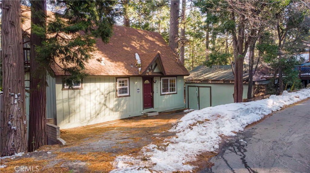 A full turnkey and approved short-term rental perched amidst the towering pines of Crestline, this enchanting three-story mountain home offers four bedrooms and two baths across 1,544 square feet, creating the perfect blend of family living and alpine getaway. Vaulted, cathedral-style ceilings and striking triangular windows fill the open great room with natural light while framing sweeping forest views, an ideal backdrop for cozy evenings by the fireplace or gatherings that flow out to the spacious balcony for dining and fresh mountain air. The open-concept main level features a well-appointed kitchen with granite countertops and stainless steel appliances, seamlessly connected to the dining and living areas for effortless entertaining. Bedrooms are thoughtfully arranged, with a main-level room offering balcony access and a one-and-three-quarter bath, a charming loft bedroom on the third floor with a private balcony and built-in storage, and two additional bedrooms on the lower level alongside a full bath and laundry hookups. Outside, a tiered wooded backyard provides ample space for pets or play, while parking for 3–5 vehicles makes hosting guests a breeze. Just minutes from Lake Gregory and Lake Arrowhead, and under an hour from Big Bear, this inviting retreat offers easy access to hiking, skiing, and year-round outdoor adventures—your perfect mountain sanctuary awaits.