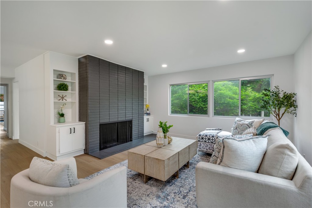 Welcome to Bellegrove—an iconic historic landmark in the coveted South Orange Grove neighborhood. Designed by renowned architect Harold J. Bissner in 1958, this beautifully remodeled single-story Mid-Century gem offers timeless charm with today’s modern comforts. Step into a spacious 1,457 sq ft layout featuring bright natural light, elegant vinyl floors, and upgraded lighting throughout. The grand living room shines with a cozy fireplace, hardwood floors, and French doors opening to a lush private patio—perfect for enjoying al fresco meals or watching the Rose Parade. Entertain in the large dining room complete with built-ins and a sleek wet bar, or cook with ease in the gourmet kitchen featuring upgraded LG appliances, generous storage, and a sunny breakfast nook with direct access to the driveway. This home features two spacious primary suites, each with their own en-suite full bathroom, ample closet space, and private balconies. Additional highlights include ceiling fans, in-unit washer and dishwasher, and a two-car detached garage located close to the unit. The mid-century details paired with modern upgrades make this home a rare find in a premier location. This is a historical property and benefits The Mills Property Tax Act. Don’t miss this perfect blend of history, style, and comfort