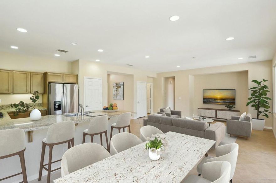 Experience the ultimate in resort-style living at Trilogy La Quinta, a premier 55+ community designed for relaxation and connection. This charming Maurea plan spans 1,386 sq. ft., offering 2 bedrooms and 2 bathrooms with an inviting open-concept design. The great room features elegant tile flooring, a built-in TV/media niche, and abundant natural light streaming in from the rear yard. The adjacent gourmet kitchen is a chef's delight, showcasing stainless steel appliances, granite slab countertops and backsplash, a breakfast bar, built-in oven and microwave, and a convenient pantry. Retreat to the serene primary suite, complete with a bay window, spacious walk-in closet, dual vanities, and an oversized tile-encased shower. Step outside to a large, extended covered patio, perfect for seamless indoor-outdoor living and entertaining. Don't miss your chance to embrace the Trilogy lifestyle--schedule your showing today!