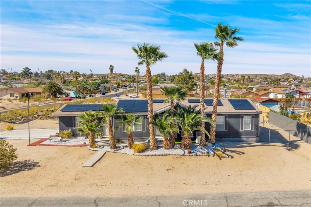 Best deal on a Newer Home in 29 Palms!
Discover this beautifully maintained manufactured home situated on a desireable corner lot. Featuring an attached 2-car garage and a fenced side yard, this property offers both convenience and privacy. Lush foliage enhances the outdoor space, creating a serene atmosphere just a stone's throw away from local shops and restaurants – perfect for those who enjoy the convenience of walking to amenities.
Step inside and be greeted by rich colors and stylish decor that provide a warm and inviting ambiance throughout the home. The layout flows seamlessly from the garage into the kitchen and dining area, making it easy to entertain or spend quality time with family. The cozy fireplace in the den area adds a touch of comfort, making it the ideal spot to relax after a long day. This home feels super solid with a cement block foundation.
With a newer build and central location, this home truly boasts all the amenities you could desire. The leased solar panels keep energy costs affordable, (currently covers all use) making this property not just beautiful but also economical.
Don't miss out on this opportunity to own a lovely home that combines comfort, convenience, and style! Schedule a viewing today!