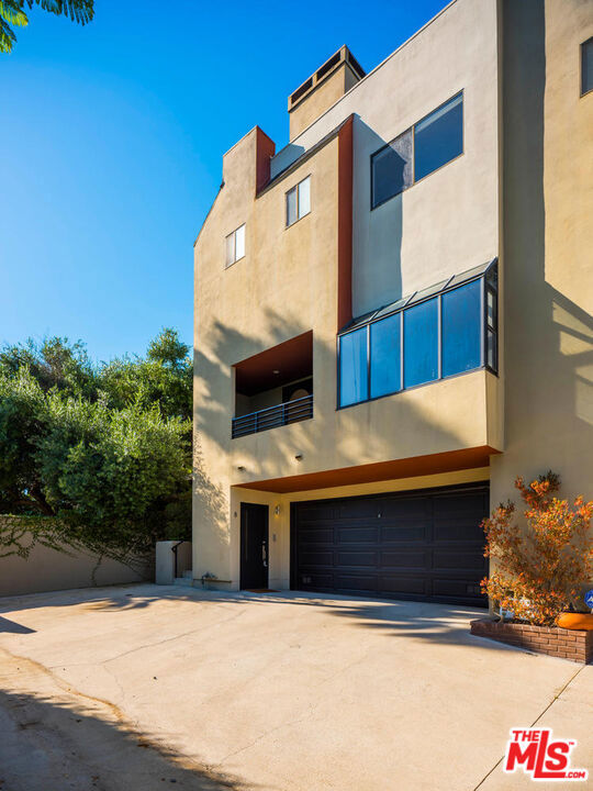 A stylish architectural tri-level townhouse with sweeping views is nestled in the Silver Lake hills and is in the best private & gated complex in the area. This top row corner unit, with only one shared wall, features a spacious sunken living room with a high ceiling filled with light, a wall of windows, plank flooring & a balcony with views out to the downtown skyline & surrounding hills. The dining room with built-ins is the perfect spot for a dinner party for your many guests. The cooks' kitchen features granite countertops, a stainless-steel sink, a built-in microwave, high-end appliances & opens to your private patio, perfect for al fresco dining. A third bedroom with a vaulted ceiling and a half bath completes this level. The upper level boasts a large primary suite with a spa tub, separate shower & a large walk-in closet + a guest bedroom with an en-suite bath, & a laundry closet off the hallway. Close to cafes, restaurants, the reservoir & all that Silver Lake has to offer. Central A/C+ + a private 2-car garage. All carpets have been removed and replaced with plank flooring. Available to move in on September 1st.