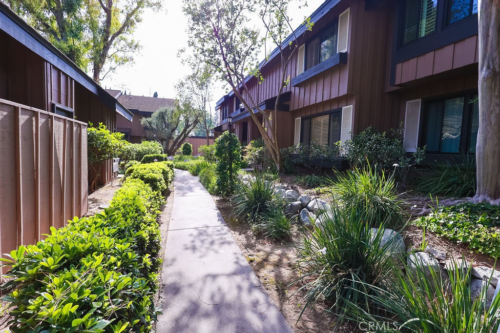 Set within a peaceful, tree-lined neighborhood filled with greenery and flowering plants, this turn-key condo offers the perfect balance of natural serenity and urban convenience. This spacious two-story unit features 2 generously sized bedrooms, a versatile bonus room, and 2.5 updated bathrooms. Located just a short walk from California State University Northridge (CSUN), this home is ideal for families, professionals, or students seeking peaceful living in a vibrant neighborhood. Step into an expansive living room that flows seamlessly into a bright and open dining area, perfect for entertaining. The updated kitchen is a chef’s dream, boasting ample cabinetry with soft-close doors and drawers, new stainless-steel appliances, and a walk-in pantry for all your storage needs. A convenient half bath and closet are tucked just behind the living room for added function. Upstairs, discover a thoughtfully designed layout. At the top of the stairs, you'll find a spacious bonus room, perfectly suited to serve as a bright and inspiring home office, a cozy guest retreat, or an additional bedroom to fit your needs. Just down the hallway to the right awaits the first bedroom, thoughtfully designed with a sleek, wall-to-wall customizable wardrobe system, and complemented by its own full bathroom for added privacy and convenience.
Further down the hall lies the expansive primary bedroom, an impressive sanctuary with ample room to create the bedroom of your dreams. This serene space features an extended walk-in closet ideal for even the most extensive wardrobe, and a luxurious en-suite bathroom complete with a dual-sink vanity and large shower, offering both style and functionality for everyday living. Enjoy indoor/outdoor living with a private patio just off the dining area, ideal for alfresco dining or a quiet morning coffee. A mature lemon tree graces the patio, yielding over 100 lemons a year, adding charm and flavor to your home life. The detached, finished two-car garage is insulated and equipped with a ceiling-mounted storage rack, if offers space for a washer/dryer, extra refrigerator, gym equipment, workbench, and more. This home has been lovingly maintained with thoughtful upgrades all throughout. The peaceful, well-established community that offers a welcoming, family-friendly atmosphere. Amenities include two tennis courts, a community pool, and meticulously maintained landscaping that enhances the neighborhood’s charm.