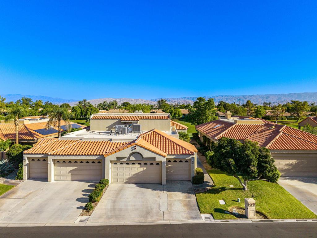 Spectacular Updated Contemporary Finishes and Outdoor Living with Mountain and Fairway Views. Great Room with fireplace, entertainer's bar, newer contemporary flooring and walls of glass highlighting views opens to Dining Room and Kitchen. Updated Kitchen features quartz countertops, stainless steel appliances, counter seating open to Great Room and island all with slider access to the Terrace. A Primary Suite on the main level includes an updated Bath featuring dual vanities, stand alone spa tub and shower. A second bedroom and bath on the main level provide great space for guests or an office/den. Upstairs is a second Primary Suite/3rd Bedroom - a great retreat complete with updated bath featuring dual vanities, stand alone tub, shower and walk-in closet. Outside is a covered outdoor living room and Terrace overlooking the golf course and mountain views. Great HOA and fee land. Come home to your desert retreat!