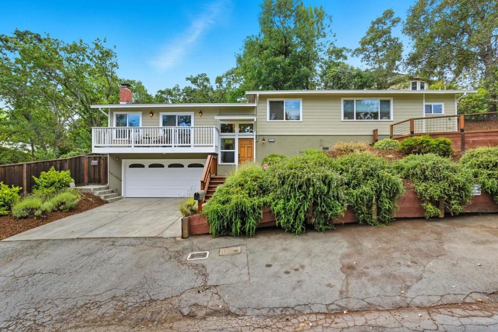 Tucked away on a quiet, tree-lined street, this beautifully appointed 3-bedroom, 2-bath split-level home offers incredible privacy, coupled with comfort and contemporary design. The open floor plan showcases gleaming hardwood floors and a seamless flow between living areas - ideal for both entertaining and everyday living. A spacious living room with a wood-burning fireplace and large picture window invites natural light and warmth, while the adjacent dining area opens to a thoughtfully updated kitchen featuring marble countertops, stainless steel appliances, and a convenient breakfast bar. All bedrooms and baths are located down the hallway for optimal privacy, including a serene en-suite retreat with a walk-in closet. Additional highlights include a two-car garage and a drought-tolerant yard with artificial grass lawn, perfect for play, outdoor entertaining, or quiet relaxation. Walking distance to Roosevelt Plaza, Key Market and Red Morton Park! Minutes to thriving Downtown Redwood City with restaurants, shops, theaters and Caltrain. Ideally situated between 101 and 280 freeways, this home offers comfort and accessibility.