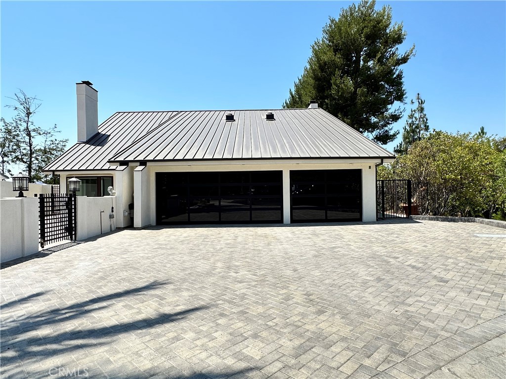 This meticulously designed 4 bedroom, 4 bath home radiates timeless elegance and charm, offering breathtaking panoramic views from both levels. Upon entering the main floor, you are greeted by an expansive living room with soaring ceilings and a cozy fireplace, creating a warm and inviting atmosphere. The living room flows seamlessly into the dining area and entertainer’s kitchen, which is designed to highlight the stunning views.
There is a sunken family room complete with a second fireplace. A wet bar adds a touch of elegance, perfect for hosting, while doors open to an expansive deck that showcases incredible views, ideal for outdoor relaxation and dining.
On this level, you will also find a versatile bedroom with a built-in bookcase that effortlessly converts into a Murphy bed, along with an adjacent bathroom for added convenience.
An elegant staircase leads up to a spacious foyer, which opens into three additional bedrooms and three full bathrooms. The opulent primary suite is a true sanctuary, complete with a private covered deck offering captivating views. Inside, the suite features a third fireplace, a walk-in closet, and a spa-like ensuite bathroom with a walk-in shower, soaking tub, double sinks, and an additional walk-in closet.
With a three-car garage and a stamped concrete driveway, this home offers impressive curb appeal. Nestled at the end of a peaceful cul-de-sac, this exceptional property strikes the ideal balance of privacy, tranquility, and convenience.