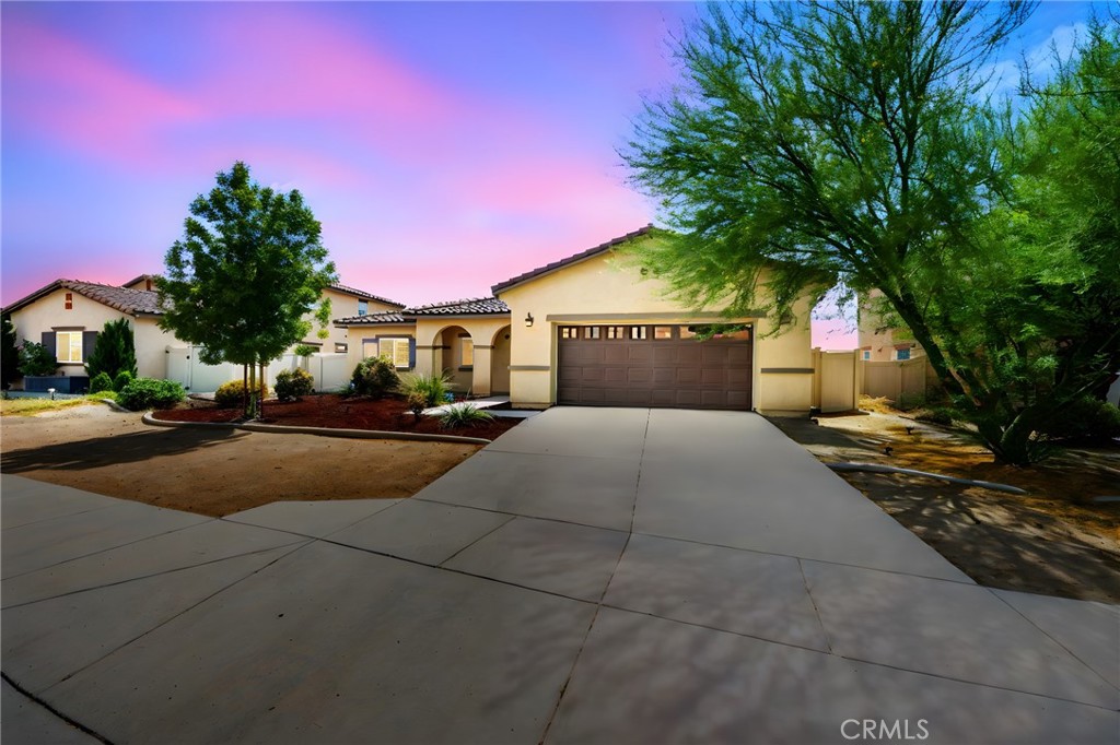 Welcome to a beautifully maintained single-story home located in the growing city of San Jacinto. This thoughtfully designed residence offers 3 spacious bedrooms, 2 full bathrooms, and approximately 1,550 square feet of modern living space. From the moment you arrive, you’ll notice the home’s charming curb appeal, accented by a clean exterior, well-kept landscaping, and a welcoming entryway that sets the tone for what’s inside. Step through the front door and into an open-concept floor plan that seamlessly connects the main living spaces. The Great Room is bright and inviting, featuring abundant natural light and laminate flooring that flows throughout the home. The adjoining dining area and chef’s kitchen make entertaining effortless. The kitchen boasts sleek white cabinetry, solid surface countertops, a spacious center island with breakfast bar seating, and plenty of storage for all your culinary needs. Whether you’re hosting family gatherings or enjoying a quiet meal at home, this space is both stylish and functional. The primary suite serves as a private retreat with a generous layout, spa-like bathroom, and walk-in closet. The ensuite includes dual sinks, a relaxing soaking tub, and a separate walk-in shower, creating the perfect place to unwind. Two additional bedrooms are versatile and can easily be used as guest rooms, children’s rooms, or a dedicated home office. A full second bathroom, conveniently located, rounds out the interior spaces. Outside, the backyard is a true highlight. Designed for low maintenance yet high enjoyment, it features xeriscaped landscaping, a custom Alumawood patio cover, and a built in fire pit ideal for evening gatherings, weekend barbecues, or simply relaxing after a long day. This home also comes with a highly affordable solar lease, allowing you to enjoy energy efficiency and reduced monthly utility costs. Situated in a friendly neighborhood with close proximity to schools, parks, shopping, and dining, this home offers everyday convenience with a touch of modern style. Commuter routes are easily accessible, making it a great choice for those needing to travel to nearby Riverside, Temecula, or the greater Inland Empire. Move-in ready and full of charm, an ideal opportunity for families, first time buyers, or anyone looking for a stylish and sustainable place to call home. Don’t miss the chance to make this beautiful property yours and enjoy all the comfort and convenience it has to offer.