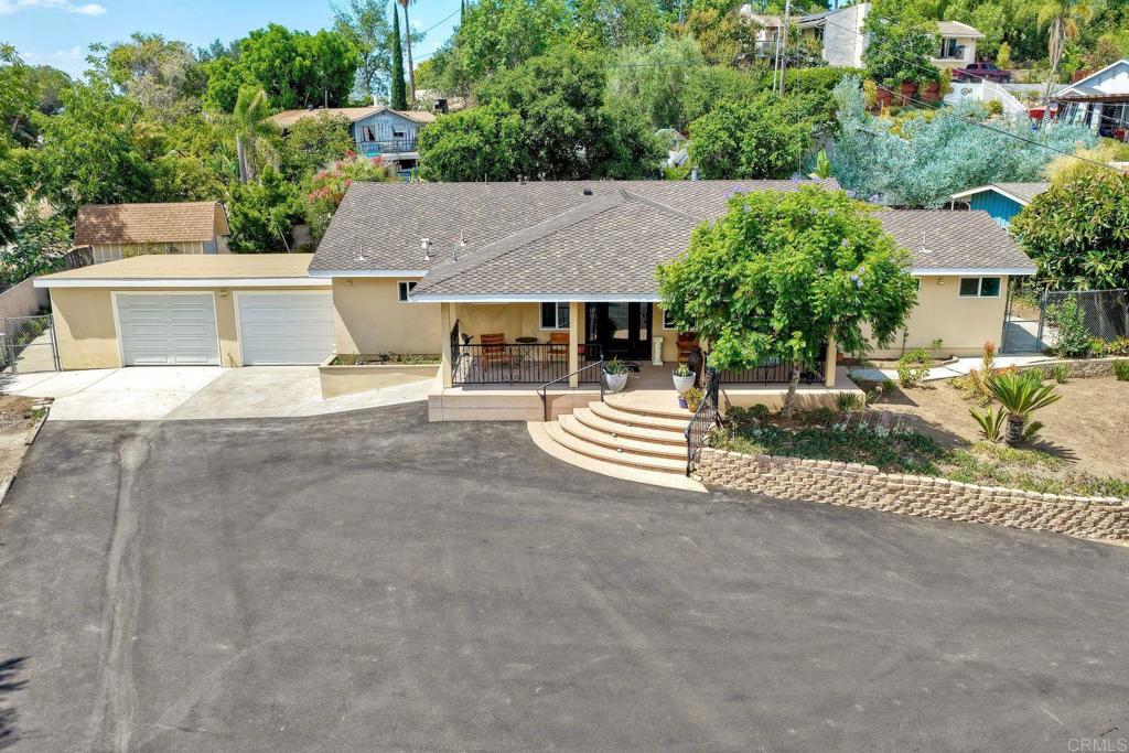 Panoramic Views, Car Enthusiast’s Dream Garage & Private Vista Retreat on 0.61 Acres. Through the gated entrance, a long private driveway sets the tone for this secluded Vista retreat, offering both elegance and functionality. With room for 15+ vehicles plus RV parking, the property was designed for those who value space, privacy, and the freedom to enjoy their lifestyle to the fullest. At the heart of the property is a 3-car garage crafted for the auto enthusiast—complete with a built-in air compressor, 220V wiring, and a rear garage door for seamless access to the backyard. Whether restoring classic cars or housing your prized collection, this garage delivers. An additional outdoor shed provides flexible storage for tools, equipment, or hobbies. Inside, the 2,150 sq. ft. single-level residence combines comfort and sophistication. Featuring 3 spacious bedrooms, 3 full bathrooms, and a dedicated office (optional 4th bedroom), the home is ideal for both families and entertainers. The gourmet kitchen boasts JennAir stainless appliances, dual electric ovens, a gas cooktop, a walk-in pantry, and a large island perfect for gatherings. Expansive windows frame sweeping panoramic views, while the family room’s wood-burning stove creates a warm, inviting ambiance. Modern upgrades add peace of mind and efficiency: a newer A/C system with updated ducting and compressor, dual water heaters, and a 5-year-old roof with a transferable 50-year warranty. Outdoors, an entertainer’s paradise awaits—featuring a built-in BBQ, generous patio space, and 220V spa wiring ready for your new hot tub—all overlooking breathtaking horizons. The large 0.61-acre lot also offers plenty of room to build an ADU, guest house, or workshop, expanding the possibilities for multi-generational living or additional income. Blending practical amenities with refined touches, this property is a rare find—perfect for the car enthusiast, the entertainer, and anyone seeking a private luxury escape in the heart of Vista.
