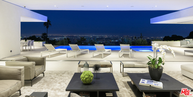 10/10 Views in Prime Trousdale. Contemporary XTEN Designed home, spanning nearly 7,000 square over ONE STORY. Perfect layout blending indoor/outdoor living space, redefining what it looks like to entertain on top of the world- with views from DOWNTOWN to MALIBU. Walls of glass open with a single touch of a button. Using only the finest materials, the home features 5 beds/ 6 bath. Gated and secure motor court is walled off by a huge custom water feature that leads into a towering glass entry. Once inside, the open floor plan has soaring ceilings, custom nine-foot solid hardwood doors & nearly 12-foot tall Fleetwood walls of glass, which vanish into the walls are dazzling. Featuring a gorgeous movie theater, secondary FULL prep kitchen, Control 4 smart home & climate controlled 1,000 bottle glass wine cellar. Backyard has lush landscaping & an outdoor fireplace with built-in seating to warm up & gaze upon the endless views. A must see property at an incredible price. Pictures do not reflect current furniture- Shown to prequalified clients only.