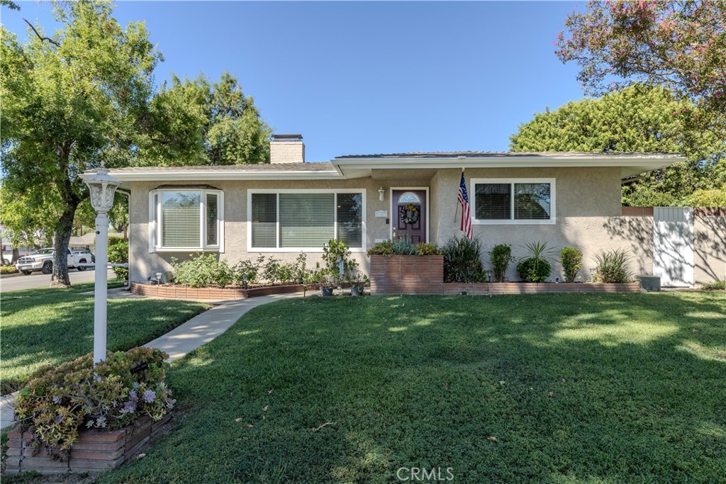 Fabulous corner lot on a beautifully tree lined street in a desirable neighborhood. This home has been well maintained by owners of 35+ years, and features a 4 bedroom and 2 bathroom layout with a direct access 2 car garage. The entry highlights laminate wood flooring and natural light throughout a spacious living area with a double sided fireplace that flows into a fireside dining room and a secondary living room. Sliding glass doors lead to a patio sitting area with market lights and sail shades. The backyard features a large grass area, planter and garden beds, a newly painted storage shed, and ample room to consider an ADU with dedicated parking. This home has incredible space for parking with two RV parking areas (one of them fully fenced), driveway parking for 3 to 4 cars, and street parking for guests at the frontage all in addition to the two car garage. This home has just been freshly painted inside and features new ceiling fans in bedrooms. The home’s exterior has been stucco patched and freshly painted. The house is equipped with ring doorbell camera, nest thermostat, My Q smart garage door opener and camera, and two Hunter smart irrigation timers for efficient watering. This space is ready for new owners to make it their own with personal updates and finishes. Great access to both the 210 and 10 freeways and local eats and shopping. Walking distance to Sierra Vista Elementary and a short drive to Pioneer Junior High or Upland High Schools.