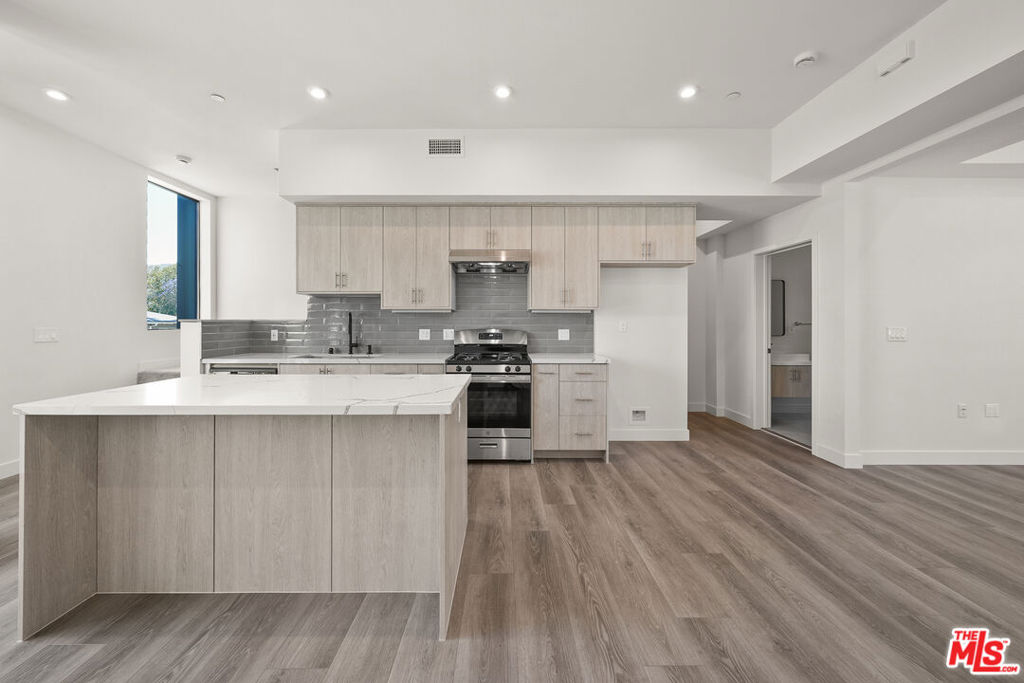 Ready to Lease! First available showing on Sunday, June 29th from 1-4pm. This 3-bedroom, 3-bathroom rental offers 1,488 square feet of thoughtfully designed living space across four levels, delivering comfort, functionality, and West Hollywood style. The entry level features a private two-car garage with direct access and a welcoming foyer that leads upstairs. On the second floor, enjoy open-concept living with a modern kitchen featuring custom cabinetry, a spacious island, and a suite of practical appliances. The kitchen flows seamlessly into the dining and living areas, creating a warm and inviting space for relaxing or entertaining. A full bathroom and a flexible bedroom ideal as a guest room or home office complete this level. The third floor includes a peaceful primary suite with a spa-inspired en-suite bath and a large walk-in closet. A third bedroom also with a walk-in closet is located just steps from an additional full bathroom. The in-unit laundry closet is conveniently located on this floor as well. Topping it all off is a private rooftop patio perfect for outdoor lounging, dining, or entertaining under the West Hollywood skyline.Ideally situated near Melrose Avenue, Santa Monica Boulevard, and some of WeHo's most iconic restaurants and shops including Catch, Craig's, and the Design District. Residence 4 offers a well-rounded rental experience in one of L.A.'s most vibrant neighborhoods.