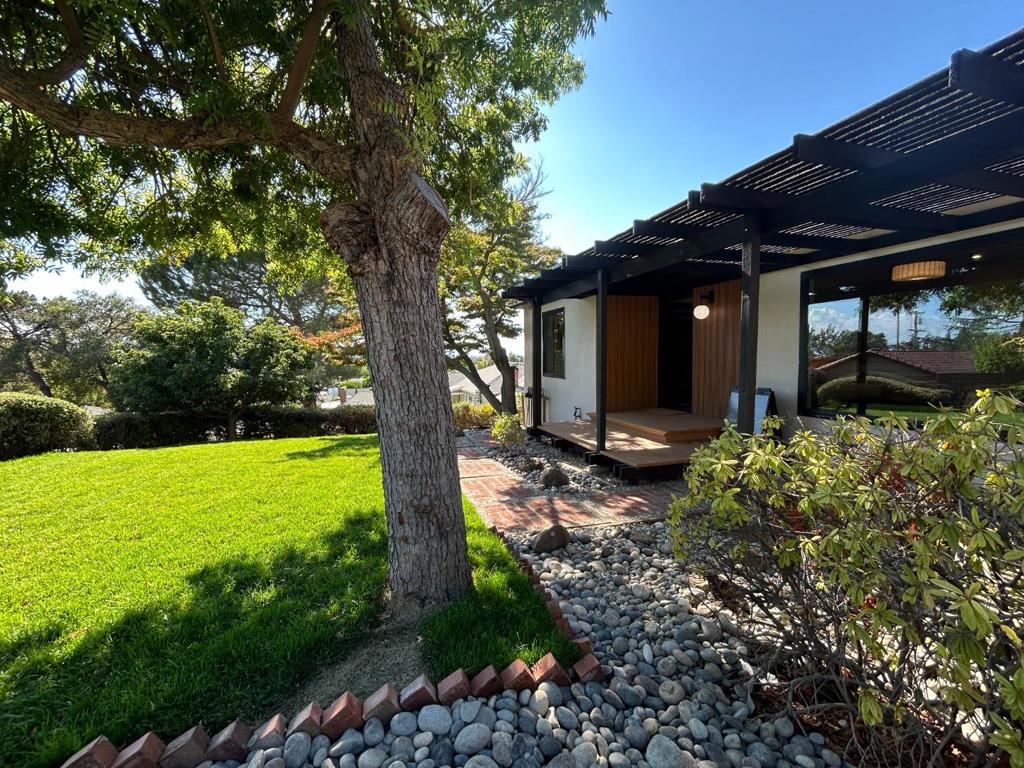 Discover serenity in this Japanese-inspired 4-bed, 2.5-bath retreat. Designed with a Japanese aesthetic, this home showcases minimalist luxury with warm wood finishes, expansive windows, and a tranquil ambiance that invites peace and reflection. Thoughtfully updated, luxurious kitchen with top of the line appliances, and spa-like baths, this home blends minimalist elegance with contemporary comfort. Expansive windows invite natural light, while the master suite offers a view of garden and city's light through a massive sliding door that opens onto a spacious wood deck, perfect for morning yoga or evening relaxation. Experience modern living with timeless Japanese inspiration. This home embraces clean lines, natural finishes, and a seamless indoor & outdoor flow, creating a serene retreat in the heart of the city. For sale fully furnished with new furniture and decoration. New 50 years warranty roof, new whole house water filter, new water heater, new epoxy floor, new side mount garage opener with battery back up and wifi control. New dual pane windows. Custom closets in all bedrooms and long list of other upgrades. This house is one of a kind. Remodeling done with permit.