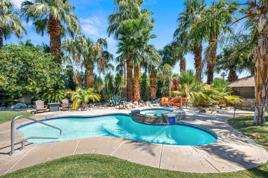 Private & Gated Rancho Mirage Mini-Estate on Over an Acre with Detached ADU and RV Garage!Discover a rare desert sanctuary in the heart of prestigious Rancho Mirage. Tucked away on over an acre of meticulously landscaped grounds, this fully enclosed and gated mini-estate offers unparalleled privacy and versatility. Surrounded by a lush wall of mature Ficus, the property is a hidden oasis.The main residence is a captivating single-family home with mid-century character, featuring 4 bedrooms and 3 bathrooms. High, beamed ceilings and distinctive round windows create a unique architectural charm. The home has been thoughtfully updated with a new kitchen, modern flooring, fresh paint, fireplace, contemporary lighting, and efficient tankless water heaters. Comfort is paramount with two primary suites, both beautifully remodeled in recent years. An attached, fully enclosed two-car garage provides added convenience.At the far end of the property, discover the detached Accessory Dwelling Unit (ADU), a perfect retreat for guests, extended family, or potential rental income. The ADU is completely private, with its own new electronic gate entrance, and features a full kitchen, separate bedroom, full bathroom, patio and laundry facilities.Car enthusiasts and adventurers will be drawn to the brand new, oversized 2-car/RV garage, offering ample space and full RV hookups. Significant investment has been made in the grounds, including new irrigation and professional landscaping, creating a serene and beautiful environment. This is a unique opportunity to own a private, multi-generational compound with modern amenities and classic desert charm.