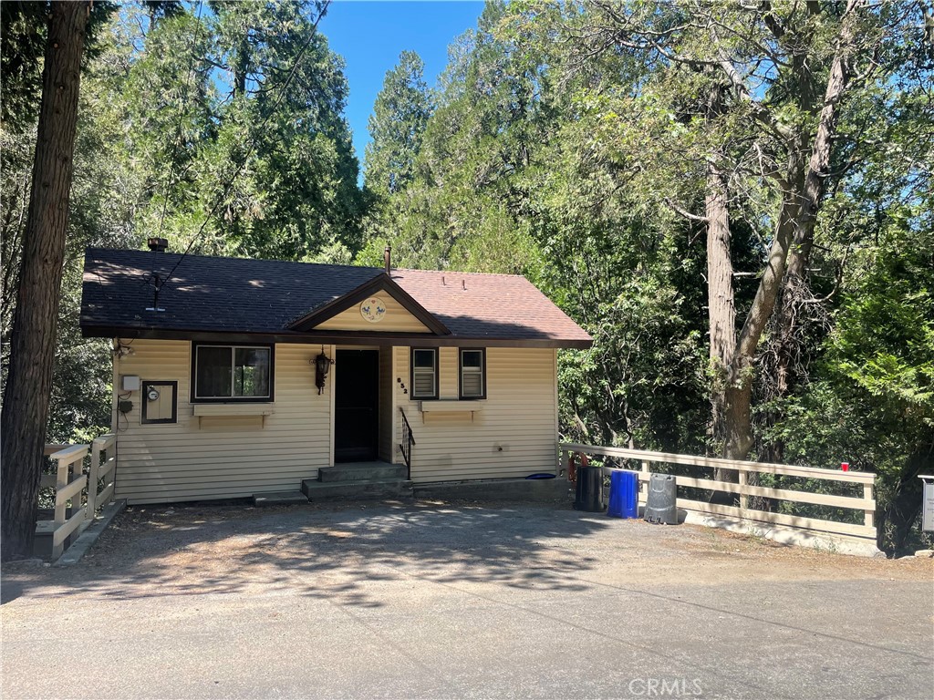 Super nice home with 3 car parking in front, and level entry to the top floor with a full length balcony, a skylight, a beautiful stone fireplace in the living room, 1/2 bath, a big kitchen with lots of storage and counter space and a walk in pantry with stackable washer/dryer hookups. Downstairs is a nice sized landing area with a full bath and 2 bedrooms, both of which access a full length balcony. Stairs on exterior access a nice sized studio, perfect for a home office, guests, or multigenerational living. Downstairs studio has a 3/4 bath, a kitchen area and its own little deck to enjoy the outdoors! Relaxing tree house views, great commuter location and close to town and the lake- get away from it all 20 minutes from the 210 freeway!
