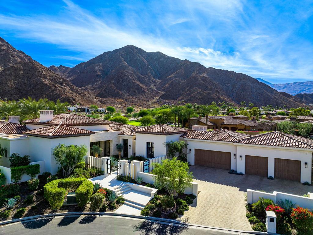 The ultimate in privacy! Welcome to this stunning, modern 4-bedroom, 4.5-bath home nestled on an expansive lot within the prestigious Tradition Golf Club. Located on a peaceful cul-de-sac, this exceptional property offers breathtaking views of the 11th hole, as well as the majestic surrounding mountains. With a dog-friendly enclosed backyard, it's the perfect setting for both family living and outdoor entertainment. Step inside to discover a beautifully designed open-concept floor plan featuring a spacious great room with pocketing doors that seamlessly blend indoor and outdoor living. The gourmet kitchen, complete with a back kitchen and bar, is an entertainer's dream. Every window offers sweeping views of the golf course and mountains, creating a serene backdrop for daily living. The well-appointed family/media room provides an ideal space for relaxation, while a cozy office area is perfect for those who need a quiet retreat. The luxurious primary suite boasts a stone wall, fireplace, stunning views, two large custom closets, dual vanities, a soaking tub, and a marble-tiled shower. Two guest suites in the main house each have spacious en-suite baths. A private casita with a kitchenette and en-suite bath offers ideal accommodation for guests. This home also features a large four-car garage and is perfectly situated for those seeking privacy, luxury, and a resort-style lifestyle at Tradition Golf Club. Offered furnished per inventory.