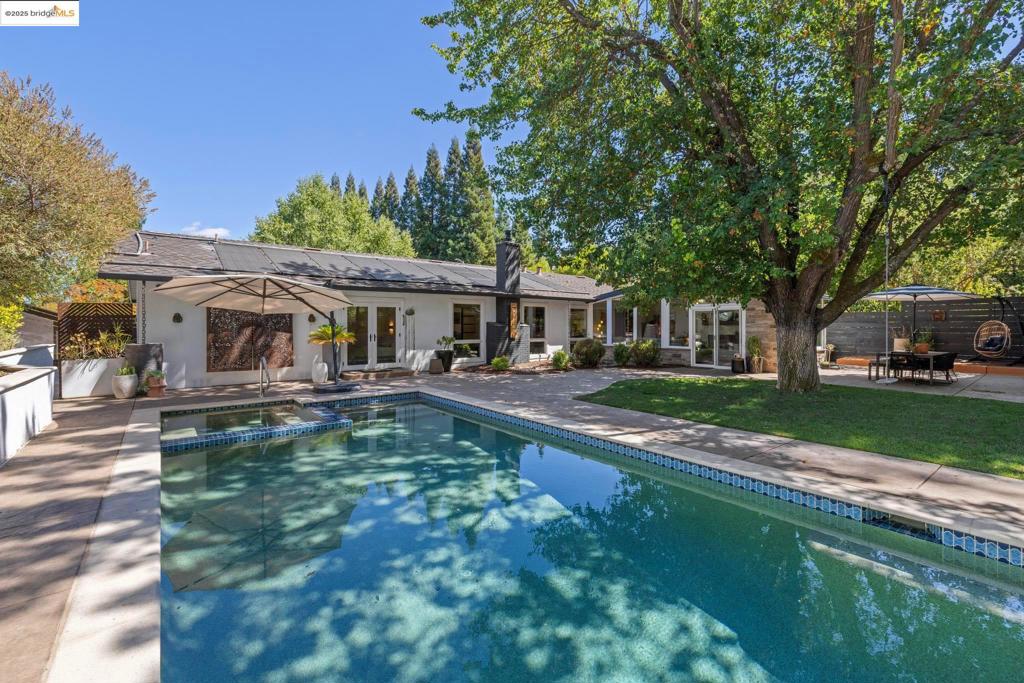 Nestled on a quiet cul-de-sac near Reliez Valley, this reimagined Modern Rancher invites you to experience smart design and effortless California living. One step inside and the heart and soul of this single level 4 bed/2.5 bath home is immediately revealed. The open floor plan is pure casual elegance, with a sunken living room centered around a sculptural fireplace, seamlessly connecting to a cozy dining area, and the stunning European style kitchen that’s truly the heartbeat of the home. Its large island invites friends and family for intimate dining and sharing stories of the day. The adjacent family room features a second cozy fireplace and walls of windows framing the verdant backyard—perfect for entertaining, family game nights or curling up with a book as sunlight streams in. The generously sized bedrooms, include a luxurious primary suite with ample closets and a spa-inspired bathroom. Step outside to your private retreat with a solar heated pool, outdoor entertainment area, sauna, and lush landscaping with well water irrigation. Enjoy owned solar, and a 2-car garage with interior access and Tonal smart gym. Located near Briones Regional Park trails, this thoughtfully renovated oasis offers the perfect blend of breezy lifestyle, indoor-outdoor flow, and refined comfort.