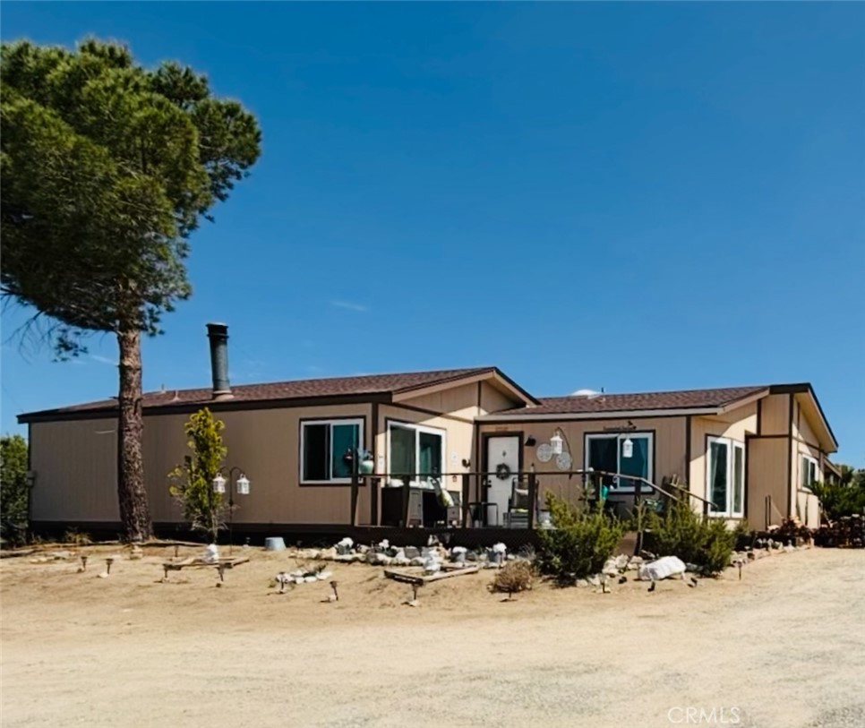 Located on the highly desirable South side of Pinon Hills, this spacious and serene home offers approximately 2.5 acres of land to call your own with stunning north-facing views and breathtaking desert sunsets. Enter the home from the large front view deck, perfect for relaxing or enjoying meals outdoors as the sky glows at dusk. Inside, you're greeted by a generous living room with soaring vaulted ceilings and a cozy wood-burning stove framed by a striking floor-to-ceiling rock fireplace. This home features brand new A/C, Furnace, Wood Flooring, Paid-off Solar, Dual-Pane Windows, and Stunning Chicken Coops. The Formal Dining Room features beautiful Bay windows that bathe the space in natural light. The adjacent upgraded kitchen features granite countertops, a tile backsplash, a central cooking island, and white cabinetry with upgraded hardware. Just off the kitchen is a spacious laundry room and additional storage. The bedroom wing of the home includes a large master suite with an oversized en-suite bathroom featuring a soaking tub, separate walk-in shower, vanity, and a large walk-in closet. The secondary bedrooms include large closets with sliding doors and easy access to a full hallway bathroom. Additional highlights include new roofing, detached double garage with electric doors, storage room next to the garage and additional backyard shed, south-facing covered deck off the laundry room, fenced property, permanent foundation, owned propane tank. Property is zoned and ready for an ADU (Accessory Dwelling Unit) — ideal for multigenerational living, rental income, or a home office. Bring your toys, animals, and garden tools — there's plenty of space to roam, grow your own food, and enjoy a peaceful, self-sufficient lifestyle. All just minutes from the mountain community of Wrightwood with skiing, snowboarding, and summer recreation. Nearby lakes include Jackson Lake, Lake Gregory, and Silverwood Lake. Also close to El Mirage dry lake bed for off-road fun. Convenient access to Hwy 138 and I-15 for commuting to the Inland Empire or Palmdale and Antelope Valley. Located in the Snowline School District, with excellent resources for homeschooling families.