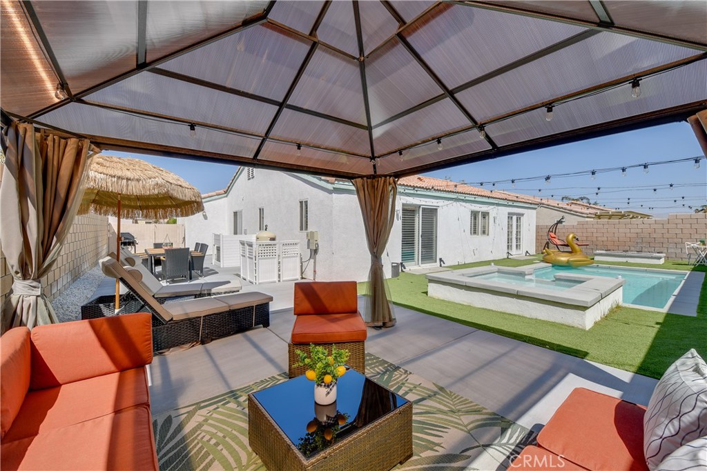 Incredible opportunity to own a beautifully upgraded 4-bedroom, 2-bathroom home just minutes from the world-famous Coachella and Stagecoach festivals — with no HOA! Whether you're searching for a primary residence, vacation getaway, or a high-demand short-term rental, this turnkey property offers exceptional value and location. Step into a bright, open-concept living space with high ceilings and a stunning, fully renovated kitchen featuring quartz countertops, large island, and new cabinetry. Inside, the primary suite offers a private en suite bathroom and a direct access to the backyard. Your private backyard oasis awaits — complete with a new heated pool and spa, and a cozy outdoor fireplace, perfect for relaxing evenings under the desert stars. The garage was converted into a game room for more fun and entertainment. With over $100,000 in upgrades, this home is truly move-in ready.