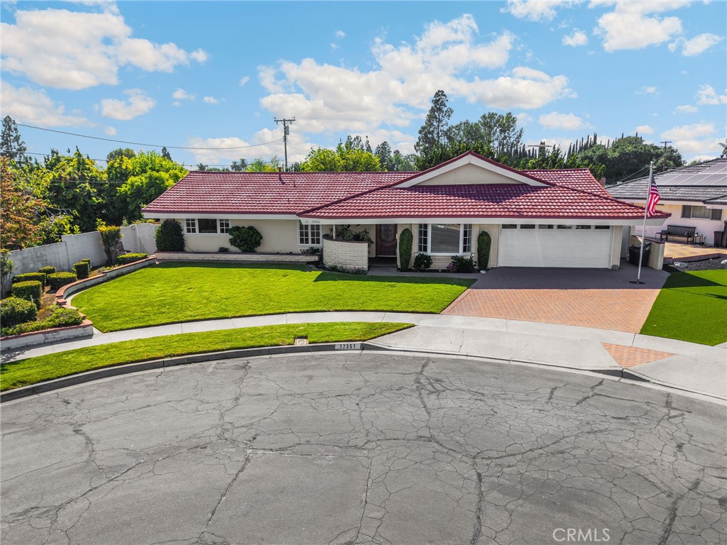 THIS HOME IS A MUST SEE! BEAUTIFUL, SINGLE-STORY home in a quiet cul-de-sac neighborhood in Yorba Linda. This home features a bright and open floor plan with 4 bedrooms, 2 bathrooms with 2,227 square feet of spacious living space on a 10,370 sq foot lot! You are welcomed at the entry into the spacious living room which features a large bay window that brings in lots of natural lighting and French doors that open into the dining room area. The kitchen features beautiful custom cabinetry, butler’s pantry area with microwave and storage, gas cooktop, built-in refrigerator and is open to the dining room. The large family room features a vaulted wood ceiling, a beautiful brick fireplace and offers views of the backyard. The Primary Bedroom Suite features a LARGE bedroom area, private bathroom with beautiful vanity with granite counter and glass enclosed shower. Down the hall are 3 spacious bedrooms with plenty of closet space and a beautiful hall bathroom with beautiful glass enclosed shower. Beautiful backyard features covered patio area with ceiling fan, built in firepit with seating, outdoor kitchen with bar seating, and beautiful mature landscaping. Additional features of the property include a spacious 2 car garage with storage and work bench, HUGE indoor laundry room with storage and access to the backyard. This home is in the Award-Winning Placentia-Yorba Linda School District, SHORT WALKING DISTANCE to Yorba Linda Middle School and Veterans Sport Park. Close to the Yorba Linda Public Library, Yorba Linda Town Center, restaurants, shopping and entertainment. Come view this beautiful house and make it yours today! Welcome Home!