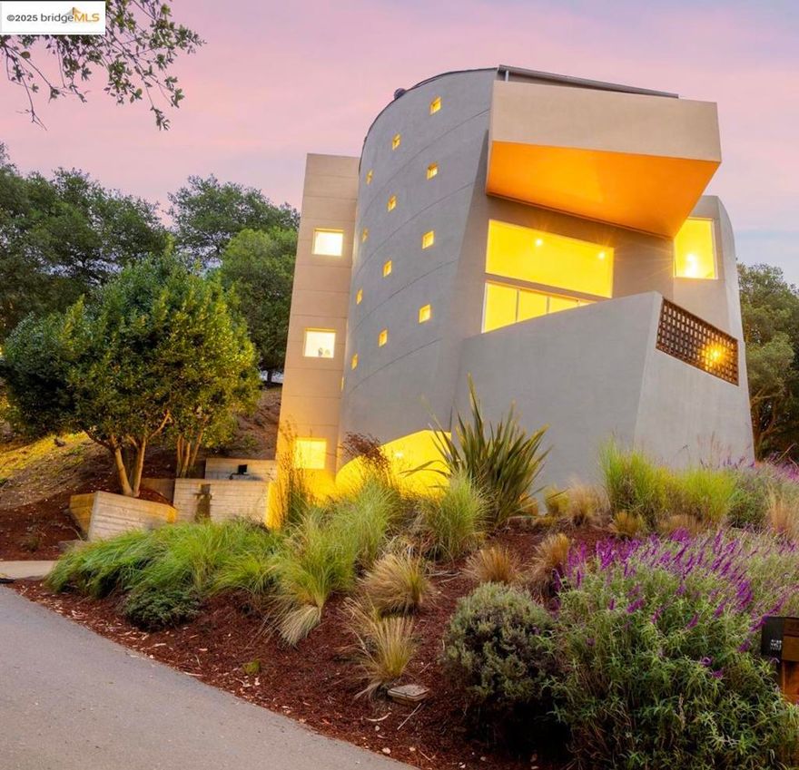Open Sun Oct 5 1-4pm! Designed by architect Michael Pearce in 1999, this striking 3 bed/2.5 bath Montclair Hills home offers 2,822 sq ft of living space on a 6,534 sq ft lot. Walls of glass showcase sweeping iconic and dramatic views of San Francisco, the Bay Bridge, and the Golden Gate.  With curves of concrete; custom wood and stone details, & radiant concrete floors, the dramatic main level features a sunken living room, elevated dining area, spacious deck, and a luxury kitchen with abundant workspace and additional eat-in/bonus area.  Upstairs, the one-of-a-kind skylight hall way ushers you to the primary bedroom with deck and a spa-inspired en suite bathroom with a secondary private deck access.  Two additional bedrooms each with outdoor private access and second full bathroom complement this level. On street level, there is an attached two car garage with interior access. Outdoor living shines with multiple decks, a grassy terrace for sunset views, a concrete custom waterfall feature in front, and drought-tolerant landscaping. This home is unique in all of the best ways; and lends itself to relaxation, entertaining and hosting, all while being in the classic Montclair Hills - close to Montclair Village, Rockridge BART/shopping, hwy 13/24, and amazing trails and hiking!