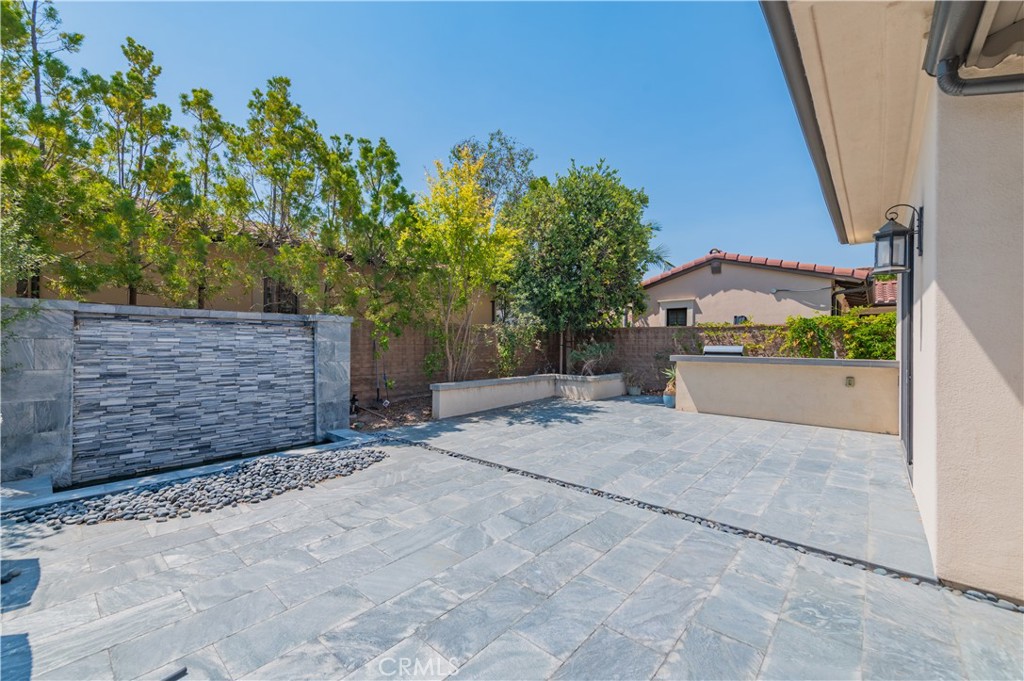 Nestled in the prestigious, guard-gated community of Orchard Hills, this stunning 4-bedroom, 4.5-bath estate offers nearly 4,800 sq ft of refined living space. Built in 2015, the home blends timeless architecture with modern elegance, featuring an expansive open-concept floor plan, soaring ceilings, and designer finishes throughout. A chef’s dream kitchen boasts premium stainless steel appliances, a large center island, walk-in pantry, and custom cabinetry, flowing seamlessly into the spacious great room with a cozy fireplace—perfect for gatherings. Each bedroom is generously sized with en-suite baths, while the luxurious primary suite offers a spa-like bathroom and oversized walk-in closet. Additional highlights include a loft, formal dining room, in-unit laundry, and abundant natural light. Outside, enjoy beautifully landscaped grounds and a private patio ideal for outdoor dining. The home includes an attached 2-car garage and is part of a vibrant community with resort-style amenities such as pools, parks, and scenic trails. Located within the highly acclaimed Orchard Hills School and Beckman High School nearby.
