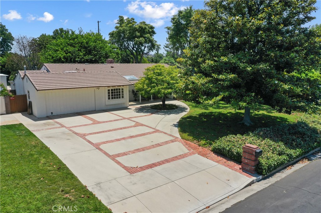 Absolutely gorgeous Sherwood Forest single story mid-century home with 3 bedrooms, 2 bathrooms, 2,050 Sq.Ft .on a 17,369 Sq.Ft. Lot with 2 car garage. Enter into the beautiful expanded living room with gleaming hardwood floors, plenty of natural light, brick fireplace, smooth ceilings, and recessed lighting. The living room is open to the dining room. Spectacular kitchen with bay window, built-in Subzero refrigerator and freezer, Miele oven, Miele dishwasher, 5 burner Thermador gas stove and custom exhaust fan, recessed lighting, wine fridge, custom cabinets, Quartz countertops, custom tile backsplash, and custom glass shelves. The kitchen has a beautiful breakfast nook with its own entrance. Large primary bedroom with mirrored closets, wood floors, and view of the tranquil backyard. Hallway bathroom with tile floors, two sinks, bay window, and spa tub. All bedrooms of good size. Third bedroom with vaulted wood beam ceiling, wood floors, track lighting, direct access to a ¾ bathroom, and door to the backyard. Large inside laundry room with included washer and dryer, extra refrigerator and separate chest freezer. Through the laundry room is a permitted attached “storage” room with a beautiful leaded glass door, smooth ceilings, and recessed lighting. There is also a whole house exhaust fan to pull outdoor air into a home through open windows. Other upgrades include: Copper water main to the street and copper piping under house, 220V dedicated outlet in garage with time-of-use meter for discounted electric vehicle charging, Nest thermostat and Nest doorbell, and newer electrical panel. Park like backyard with a large tree providing shade for a wood deck that is perfect for entertaining, huge grassy area, 3 large sheds with electrical (each approx. 30 ft. x 10 ft.), a rose garden, mature trees, and fruit trees including a fig tree, tangelo tree, lemon tree and lime tree.