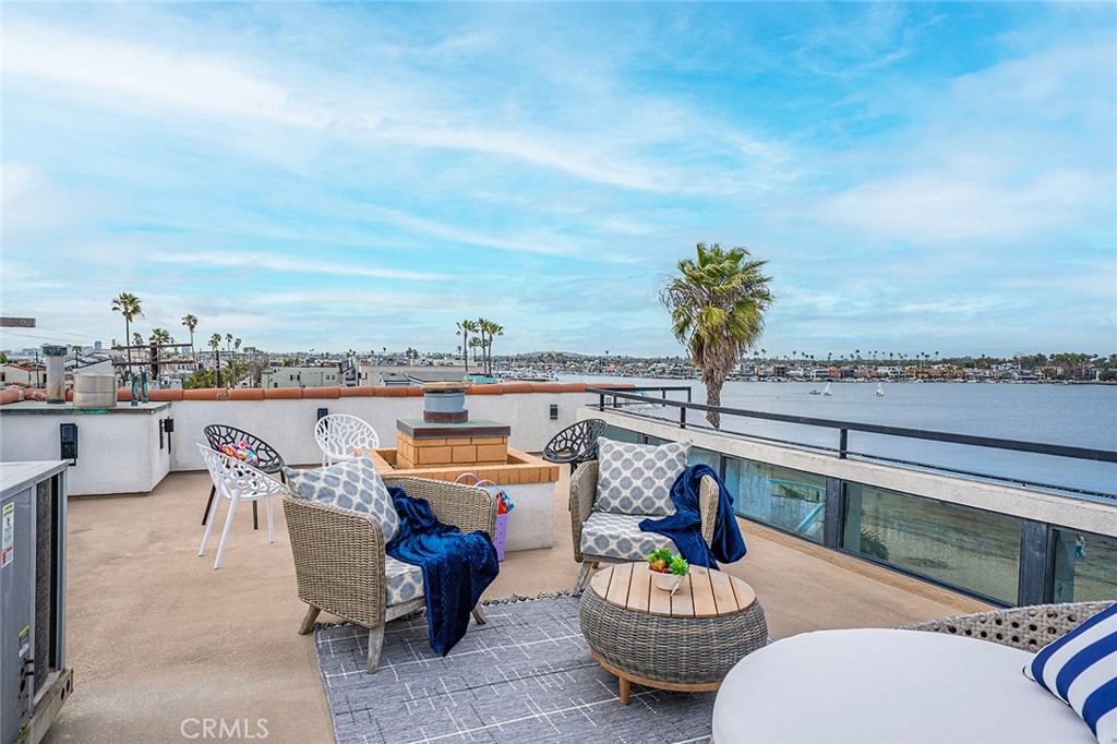 Experience the ultimate in coastal living with this beautifully upgraded custom home nestled directly on the sand of Alamitos Bay. This rare gem offers a thoughtfully designed layout featuring a top floor primary suite, two additional bedrooms, three and a half baths, and an open floor plan for the kitchen and living space all taking in amazing views of the Bay. Breathtaking panoramic views can be seen from the rooftop patio, stretching from the Palos Verdes Peninsula to Newport Beach. Catalina Island and mountain vistas over the bay complete the stunning backdrop. Whether it's sunrise or sunset, every angle of this home captures the best of Southern California's natural beauty. Inside there is a dining area adjacent to the entertainer's kitchen. The primary suite offers a sitting area, picture windows that capture the bay front views, and a walk-in closet. A spacious three car garage includes a unique rear garage door for seamless access to the beach, perfect for launching boats and paddle boards straight into the bay. The front patio gives way to a private beach feel. There is a bathroom at beach level for convenience and laundry is located here as well. This house is a true bay front retreat. As a primary residence or a second home, come Live the Peninsula Lifestyle!