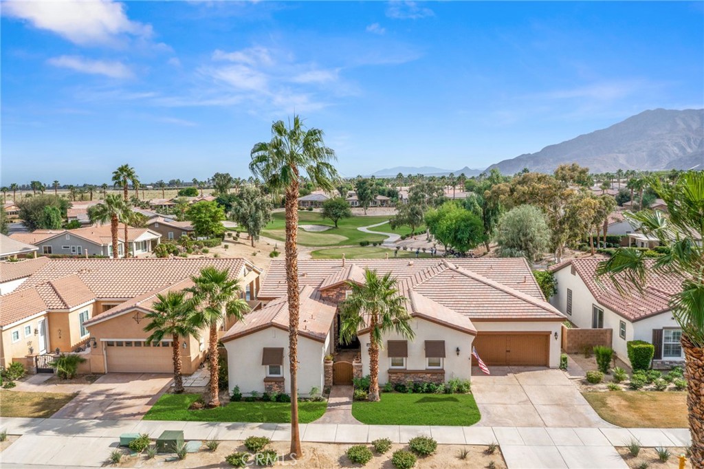 Premier Tamarisk model overlooking the 11th green of Trilogy Golf Club at La Quinta. This 2,724 sq. ft. home offers 4 bedrooms and 4 bathrooms, including a detached casita with private mini-split A/C, beverage center, and en-suite bath. Enter through a custom wood gate to a private courtyard, then into a bright great room with high ceilings, crown molding, arched doorways, and a fireplace showcasing golf course views. The chef’s kitchen features double ovens and a wine refrigerator, opening to a dining area with pool and fairway views. The south-facing backyard—highly sought after for its all-day sun—offers two covered patios and a resort-style pool and spa. The primary suite includes a spa-inspired bath with quartzite soaking tub, dual vanities, floor-to-ceiling tiled shower, and walk-in closet. Three-car garage with EV charging, workbench, and built-ins. HOA amenities include clubhouse, fitness center, pools, tennis, and pickleball.