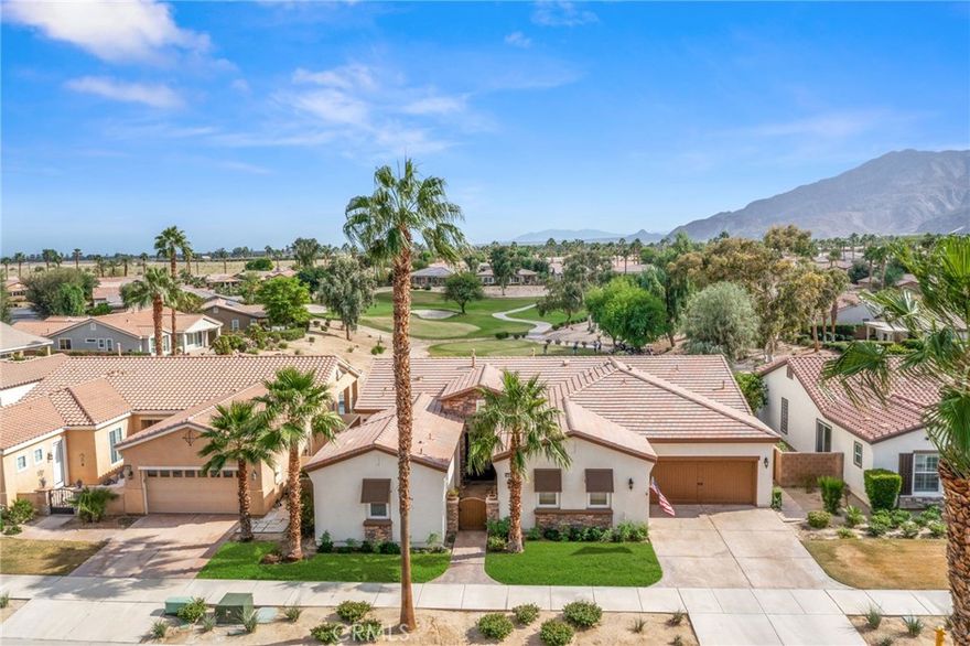 Premier Tamarisk model overlooking the 11th green of Trilogy Golf Club at La Quinta. This 2,724 sq. ft. home offers 4 bedrooms and 4 bathrooms, including a detached casita with private mini-split A/C, beverage center, and en-suite bath. Enter through a custom wood gate to a private courtyard, then into a bright great room with high ceilings, crown molding, arched doorways, and a fireplace showcasing golf course views. The chef’s kitchen features double ovens and a wine refrigerator, opening to a dining area with pool and fairway views. The south-facing backyard—highly sought after for its all-day sun—offers two covered patios and a resort-style pool and spa. The primary suite includes a spa-inspired bath with quartzite soaking tub, dual vanities, floor-to-ceiling tiled shower, and walk-in closet. Three-car garage with EV charging, workbench, and built-ins. HOA amenities include clubhouse, fitness center, pools, tennis, and pickleball.