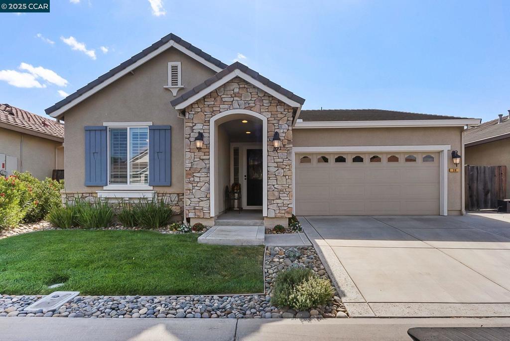 Welcome to Your New Home in The Lakes! Located on one of the most desirable streets in this sought-after gated community, this residence offers charm, comfort, and an exceptional lifestyle. From the moment you arrive, you’ll notice the incredible curb appeal and an extra-wide driveway that accommodates three additional vehicles with ease. Step outside your front door and enjoy peaceful walks around the community’s sparkling lakes, or take advantage of the many trails perfect for both dogs and their humans. The original owner has lovingly maintained this home with meticulous care, ensuring it is move-in ready. Inside, you’ll find engineered wood flooring flowing seamlessly through the main living areas, complemented by high-end carpet in the bedrooms and fresh interior paint. The family room features elegant window shutters, while the kitchen is equipped with reverse osmosis and a salt-water softener system for convenience. The primary suite boasts a custom, high-end built-in closet system for maximum organization. All appliances are included—including a top-tier washer and dryer—making this home truly turn-key.