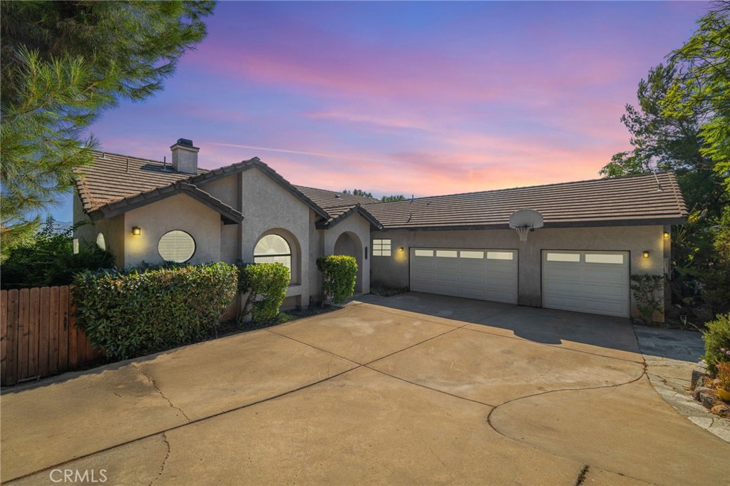 Welcome to 24443 Rutherford Rd — a beautifully maintained 4-bedroom, 2.5-bathroom home offering 2,086 sq. ft. of living space on nearly half an acre in the highly desirable San Diego Country Estates. Step inside to a bright and airy open floor plan featuring vaulted ceilings, a cozy wood-burning fireplace, and elegant plantation shutters. The upgraded kitchen boasts granite countertops, stainless steel appliances, and ample cabinet space, perfect for any home chef. The spacious primary suite includes a luxurious jetted tub, dual sinks, and serene views of the surrounding hills. Three additional bedrooms provide plenty of space for family, guests, or a home office. Outside, enjoy the expansive backyard with mature landscaping and room to entertain, garden, or relax under the stars. The 3-car garage, solar panels. Located in a vibrant community with access to golf, tennis, pools, equestrian facilities, hiking trails, parks, and more—this home combines comfort, style, and an unmatched lifestyle.