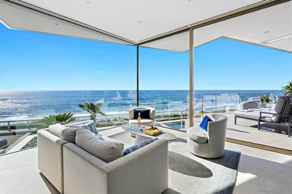Rental rates are WEEKLY. Jewel is a 2021 luxury contemporary ocean front residence like no other. Located in La Jolla perched over the world famous Windansea Beach, enjoy unobstructed white sand and whitewater views from several rooms within the home. Spanning 4,000 sq ft, this elegant 4 BR/ 6 BA home blends elegance with a unique vacation experience. The design includes 10' high glass walls, an ocean-facing pool, rooftop lounge, and designer furnishings. The state-of-the-art European inspired design yield an open floor-plan living area is filled with natural light, featuring a custom sectional, linear gas fireplace, 75” flat-screen TV with surround sound, and a sleek kitchen with Miele appliances. The adjacent Ocean Lounge boasts 180-degree views, perfect for admiring the surf and marine life. Outside, the view lounge overlooks the swimming pool, fire features and ceiling heaters provide cozy warmth for evening entertaining. A beach-level cabana bathroom, complete with towel warmers and showers, provides a convenient spot to rinse off after a swim or beach day. 2nd level features four bedrooms, each with en-suite bathrooms and custom cabinetry. The Primary Suite offers stunning ocean views, a luxurious bathroom, and a private terrace with seating. The Ocean Suite, Garden Suite, and Family Suite each provide comfort and beautiful views. The Sky Lounge rooftop offers 360-degree views and a fully stocked kitchen with a Lynx grill and fire table. An in-home gym and other amenities to enhance the experience. Call to make this oceanfront dream your reality this season!