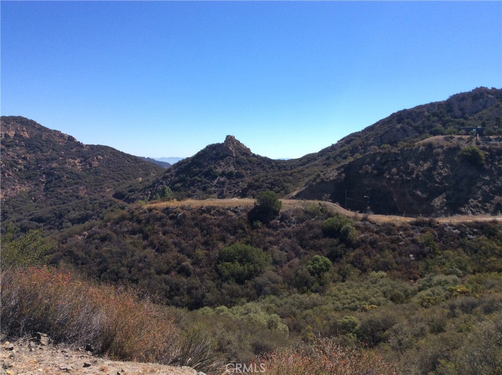 Explore this beautiful almost 40-acre parcel of pristine land, just 15 minutes west of the 101 Freeway and 20 minutes east of the Pacific Ocean along Kanan Dume Road. The property includes an almost mile-long private road, showcasing panoramic views of Conejo Valley and the Santa Monica Mountains. Zoned for single residence, agriculture, livestock, and possible vineyards, this versatile land offers endless possibilities for your vision.
Embrace the opportunity for a fully off-grid lifestyle by installing a well, solar power, and propane systems. For an aerial view, find it on Google Earth, or schedule a tour by contacting the listing agent. This property is located in the "North Area," outside the "Coastal Commission" jurisdiction.