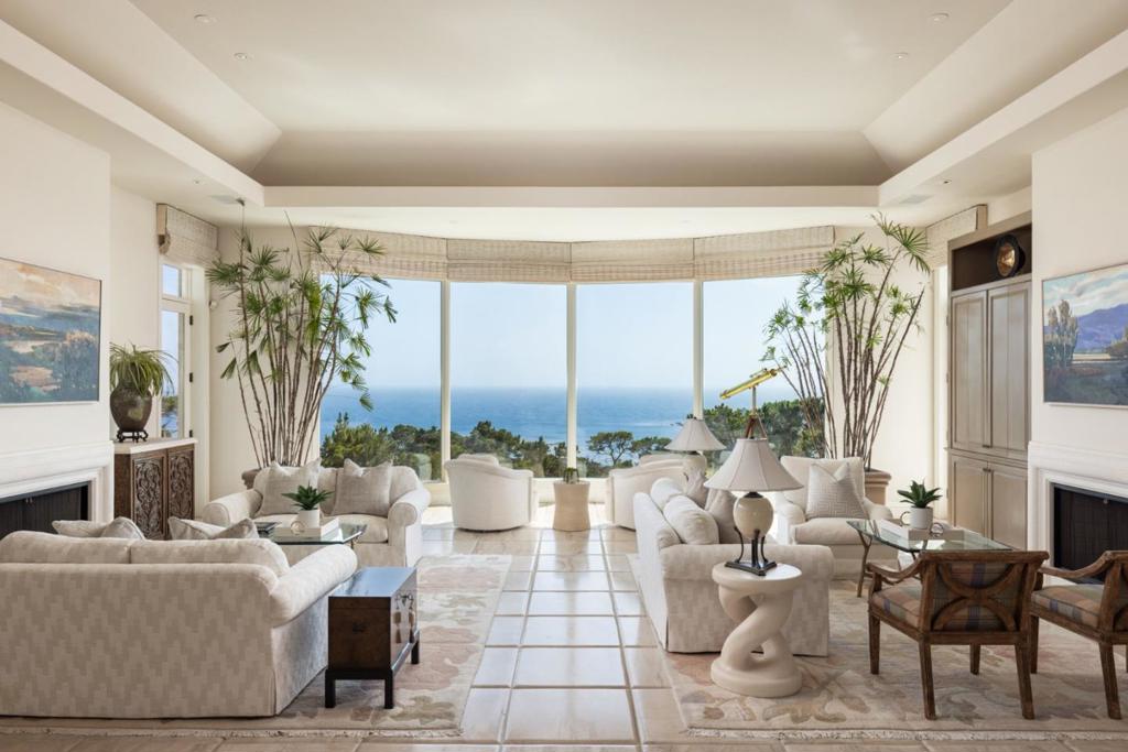 An expansive and elegant Pebble Beach estate showcasing sweeping ocean views from most roomsa rare blend of space, privacy, and stunning vistas. Designed to embrace the views, the home offers 5 bedrooms, 5+ bathrooms, and multiple flexible-use living areas ideal for both refined entertaining and relaxed everyday living. The main level features ocean views from the formal living room, family room adjoining a light-filled kitchen, the primary suite, and a formal office. The lower levelaccessible by elevator, stairs, or a garden pathincludes two guest suites plus two separate guest quarters, each with its own kitchenette and living area, ideal for extended family or visitors. A versatile sports lounge/pub with its own entrance and half bath provides a fun space to watch games, relax, or convert into a gym. Outside, the spacious backyard terrace includes an outdoor kitchen and flows into lush gardens with a fire pit, built-in stone spa, and a tranquil water feature. Indoor-outdoor living is seamless, all set against some of the most captivating views in Pebble Beach.