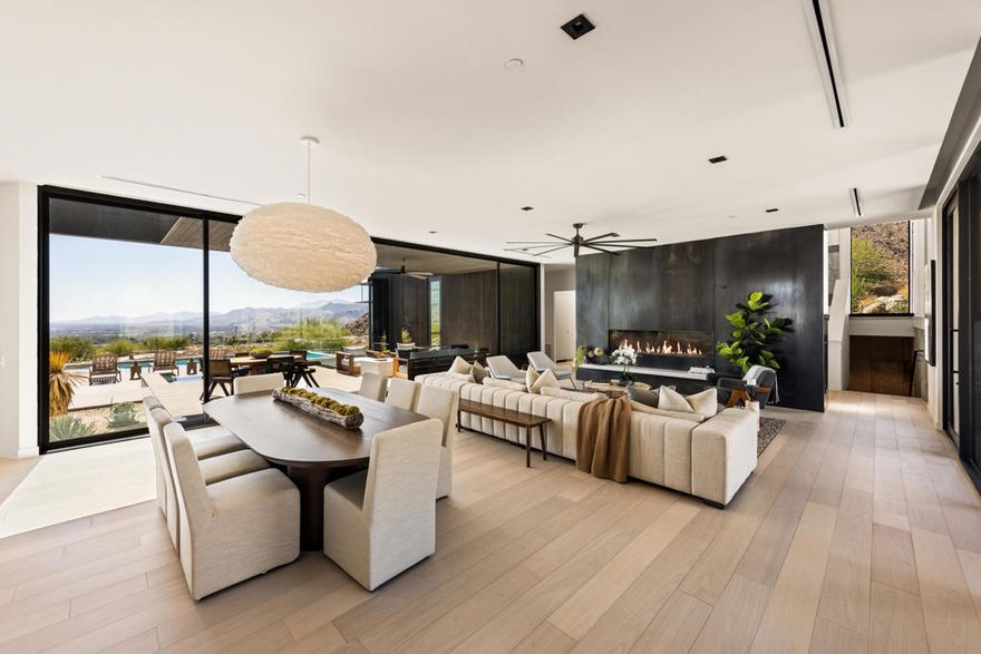 Welcome to the exclusive Desert Palisades enclave in Palm Springs, where world-renowned architects collaborate to create sustainable, cutting-edge homes. Embrace 360-degree mountain views with this newly constructed, architectural gem, surrounded by boulders and nestled in the hills at the base of the San Jacinto Mountains. Nearly 3800 sq.ft. of luxurious living space offering seamless indoor-outdoor living, a spacious open floor plan including living room and dining area, an expansive deck, meticulous landscaping, and a luxurious pool. As you enter the residence, clad in Japanese Sugi Ban wood, you are greeted with phenomenal mountain, desert and city views through floor to ceiling Monumental sliding glass doors and windows. The clear wood oak floors accent the hot rolled steel two-sided fireplace that extends from the living room to the family room/den. The gourmet Chef's kitchen is outfitted with top-of-the-line Miele appliances, two dishwashers, wine refrigerator, Hans Grohe fixtures, Blanco farmhouse-style sink, designer lighting and European-style cabinetry. The primary bedroom suite is an opulent retreat, complete with sliding door access to the outdoor patio, pool & spa, a glass-enclosed shower, luxurious free-standing soaking tub, a hallway of expansive custom closets and its own stackable washer/dryer. There are two lovely, well-appointed guest bedrooms, each with uniquely designed en-suite bathrooms providing their own spectacular mountain and city views. Each bathroom includes beautiful walk-in showers, Robern lighted medicine cabinets, in-wall tank Toto toilets, and ample closet space. Other home features include Eastern European wood interior doors, seven skylights (2 being operable), Kohler bathroom sinks, under cabinet lighting, separate laundry/utility room, 6 state-of-the-art security cameras, owned solar for energy efficiency, 5 HVAC zones and a huge 4-car garage to accommodate both vehicle and storage needs. The expansive outdoor space is an entertainer's dream featuring a built-in firepit and gorgeous custom Pebble-Tec pool with tanning shelf and separate raised spa. The spectacular 360-degree views enhance the beauty and serenity of this home's outdoor living. Surrounded by mountains, this home's design blends seamlessly with the desert landscape, embodying the architectural ethos of the Desert Palisades. Every aspect of this home has been meticulously curated to fashion an exquisite masterpiece of artful living!