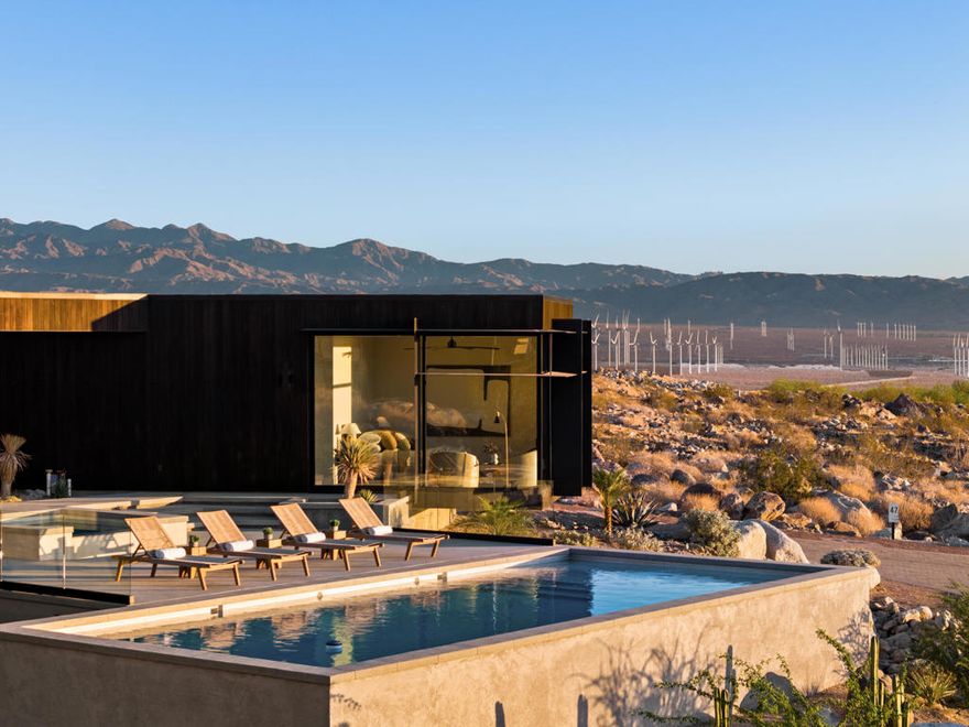 Welcome to the exclusive Desert Palisades enclave in Palm Springs, where world-renowned architects collaborate to create sustainable, cutting-edge homes. Embrace 360-degree mountain views with this newly constructed, architectural gem, surrounded by boulders and nestled in the hills at the base of the San Jacinto Mountains. Nearly 3800 sq.ft. of luxurious living space offering seamless indoor-outdoor living, a spacious open floor plan including living room and dining area, an expansive deck, meticulous landscaping, and a luxurious pool. As you enter the residence, clad in Japanese Sugi Ban wood, you are greeted with phenomenal mountain, desert and city views through floor to ceiling Monumental sliding glass doors and windows. The clear wood oak floors accent the hot rolled steel two-sided fireplace that extends from the living room to the family room/den. The gourmet Chef's kitchen is outfitted with top-of-the-line Miele appliances, two dishwashers, wine refrigerator, Hans Grohe fixtures, Blanco farmhouse-style sink, designer lighting and European-style cabinetry. The primary bedroom suite is an opulent retreat, complete with sliding door access to the outdoor patio, pool & spa, a glass-enclosed shower, luxurious free-standing soaking tub, a hallway of expansive custom closets and its own stackable washer/dryer. There are two lovely, well-appointed guest bedrooms, each with uniquely designed en-suite bathrooms providing their own spectacular mountain and city views. Each bathroom includes beautiful walk-in showers, Robern lighted medicine cabinets, in-wall tank Toto toilets, and ample closet space. Other home features include Eastern European wood interior doors, seven skylights (2 being operable), Kohler bathroom sinks, under cabinet lighting, separate laundry/utility room, 6 state-of-the-art security cameras, owned solar for energy efficiency, 5 HVAC zones and a huge 4-car garage to accommodate both vehicle and storage needs. The expansive outdoor space is an entertainer's dream featuring a built-in firepit and gorgeous custom Pebble-Tec pool with tanning shelf and separate raised spa. The spectacular 360-degree views enhance the beauty and serenity of this home's outdoor living. Surrounded by mountains, this home's design blends seamlessly with the desert landscape, embodying the architectural ethos of the Desert Palisades. Every aspect of this home has been meticulously curated to fashion an exquisite masterpiece of artful living!