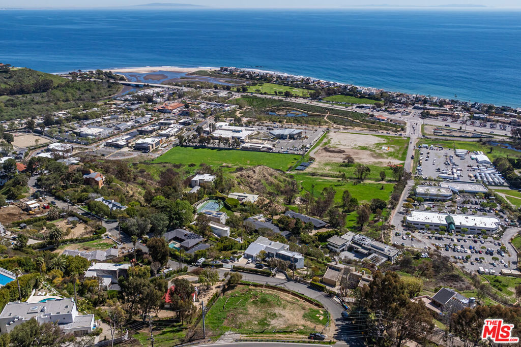 **Permits Approved Ready to Build Immediately** Build your dream estate on this stunning Malibu lot with breathtaking 270-degree ocean and mountain views, stretching to Santa Monica and Catalina Island. This rare shovel-ready property comes with fully approved plans and RTI for a 5,400 sq. ft. modern home, featuring a two-story glass-enclosed design, a subterranean garage, and luxury amenities including a pool, spa, rooftop terrace, and Mediterranean garden. The plans showcase an open-concept layout with five bedrooms, 5.5 baths, a chef's kitchen, expansive balconies, and multiple fireplaces. A gated entrance, private driveway, and elevator access ensure privacy and convenience. With permits in hand, construction can begin immediately. Don't miss this rare opportunity to own a premier Malibu lot with unparalleled views. Located at the heart of Malibu - close to Malibu's newest shopping center, Cross Creek Ranch; The Park at Cross Creek with Whole Foods, the Lumber Yard, Malibu Country Mart, Malibu Farmers Market, the Malibu Pier, Pepperdine University, PCH, the 101 Fwy and so much more.