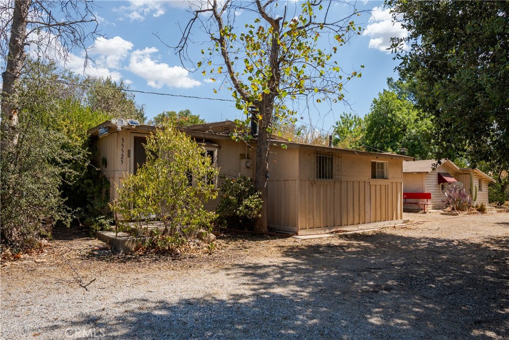 This isn’t just land. It’s part of Yucaipa’s story. Spanning over 8 acres across two parcels (5 acres + 3.45 acres), this property blends history, character, and opportunity. With sweeping mountain views and wide-open acreage, it offers endless potential for builders, investors, or visionaries.
Adding to its appeal are 3 unique structures: an 844 sq ft main home with 2 bedrooms and 1 bathroom, a 500 sq ft in-law suite with 1 bedroom and 1 bathroom, and a large barn/workshop that can also serve as a carport. Whether you’re looking to subdivide, build multiple homes, design a private estate, or create an equestrian retreat, this property is a rare canvas where possibilities come to life.