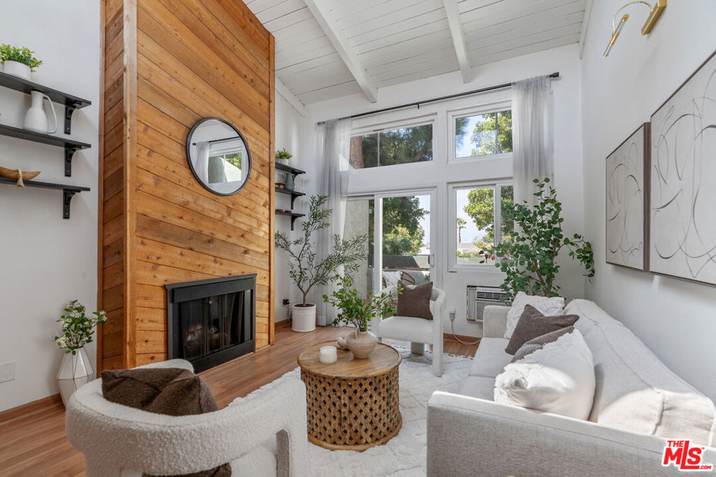 Discover a rare gem in the heart of Culver City, a 2-bedroom, 2-bathroom top-floor condo located in the highly sought-after Windsor Fountains community. This welcoming home features a spacious living room with vaulted ceilings and floor-to-ceiling windows that fill the space with abundant natural light. The living room's centerpiece is a stylish wood-paneled accent wall that frames the decorative fireplace, adding charm and character to the space. Step onto the oversized turfed patio and enjoy picturesque views of the tree-lined street. The kitchen offers plenty of cabinets for storage, exposed wood shelves for a touch of rustic charm, stainless steel appliances for modern convenience, and a breakfast bar that's perfect for casual dining and entertaining. Unlike many other units in the complex, this condo offers the convenience of in-unit laundry. The primary suite boasts dual closets for ample storage, while the generously-sized second bedroom, equipped with a custom closet, adds to the condo's appeal. Guests have easy access from Overland Ave, and two covered parking spaces in the subterranean garage ensure security and convenience. The HOA amenities are truly exceptional, featuring a community pool and spa, a recreation room/clubhouse, BBQ areas, tennis courts, and serene water features. An on-site property manager adds to the convenience of living here. Situated within the highly acclaimed Culver City Unified School District and just minutes away from Sony Studios, Downtown Culver City, and the La Ballona Creek bike path to the ocean, this condo offers a remarkable opportunity to experience the very best of Culver City living. Don't miss the chance to make Windsor Fountains your home, with trendy eateries, shops, and local hotspots just steps away.