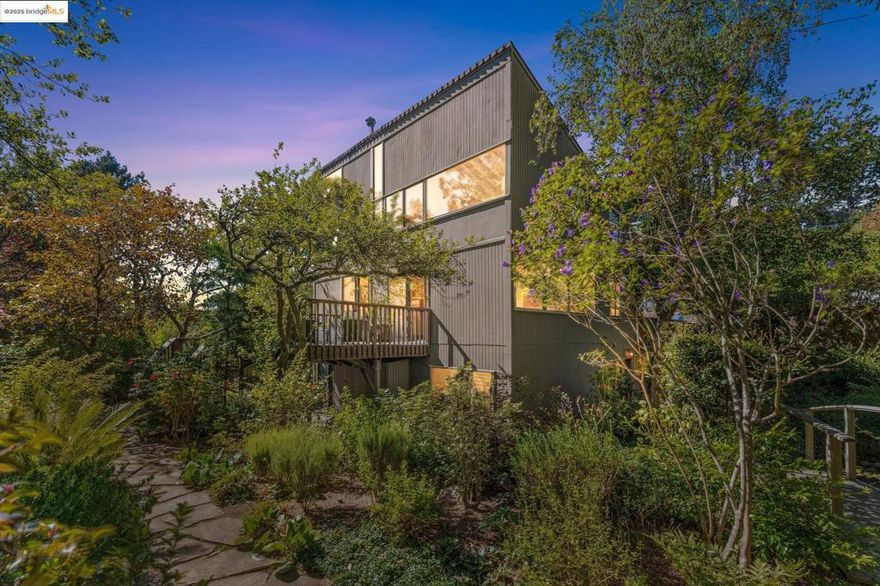 Nestled at the end of a cul-de-sac in the Berkeley Hills near Tilden Park, this home offers a peaceful retreat with stunning gardens and unparalleled privacy and serenity. Custom built in 1967 by the current owners, the warm and inviting atmosphere features a high vaulted entryway and an open-concept living area with redwood paneled ceilings and custom details. Large windows throughout the home frame stunning views of the gardens and adjacent open space. The thoughtful design creates a perfect balance of shared and private spaces, with 4 bedrooms, 3.5 baths, a comfortable den, and a large office with built-in desks and bookcases.  An expansive outdoor deck connects the main living space with beautifully landscaped gardens, mature fruit trees, stone walkways, seating areas, and a seasonal creek. The spacious 4th bedroom has direct access to the garden and side deck.  This house is lovingly maintained, with freshly refinished hardwood floors throughout and a new class A fire rated roof with transferable warranty. This is the perfect sanctuary for those seeking quiet, access to nature, and proximity to UC Berkeley and the vibrant culture of the Bay Area. A must-see! Bonus: PG&E is undergrounding wires for additional fire protection.  Street repaving slated for early 2026 per PG&E.