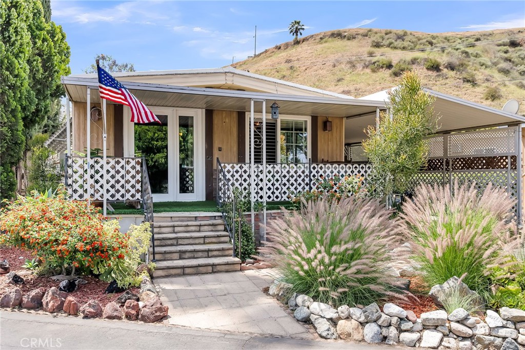 Awarded the Reche Canyon Mobile Estates best curb appeal award, this beautifully and lovingly maintained 2-bedroom, 1-bath home offers comfortable living with a spacious layout and a range of appealing features. Step inside to discover elegant flooring throughout and a beautifully upgraded kitchen with modern countertops that bring both style and function. The living space flows seamlessly, perfect for relaxing or entertaining guests. Enjoy outdoor living with an ample-sized fenced in yard with no back neighbors—ideal for gardening, BBQs, or simply soaking up the California sunshine. This is one of the most exclusive and highly desirable lots in the entire community! A carport provides convenient covered parking, and you'll love the shared basketball court, pool, clubhouse and park.