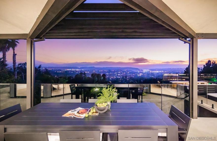 This hilltop home in Carlsbad, California, has been transformed into a breathtaking modern sanctuary. Set on a one-acre lot with sweeping views of the Carlsbad lagoon and Pacific Ocean, the property underwent a comprehensive remodel that blends contemporary elegance with purposeful functionality.  Inside, the home features a mix of bespoke elements—from custom sofas and a liquid metal-finished fireplace to thoughtfully curated artwork that highlights local talent. Clever design choices, like a hidden pantry door and a discreet cooking station, bring both practicality and charm to the kitchen. The primary bathroom includes a spa-like wet area, creating a private escape within the home.  Outdoors, an infinity-edge pool appears to flow directly into the ocean, while the beautifully landscaped grounds offer a peaceful setting for both relaxation and entertaining. This reimagined residence captures the essence of modern California living, where elevated design meets timeless comfort.