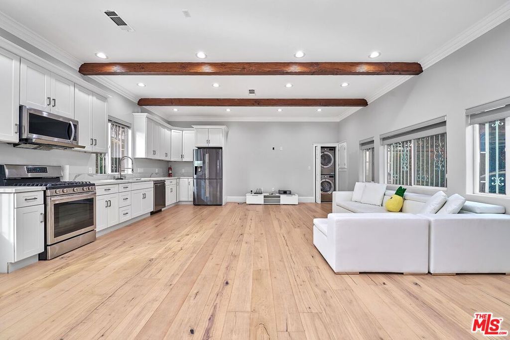 Built in 2020, this stylish attached ADU with private entry features 2 bedrooms and 2 bathrooms in one of the area's most desirable neighborhoods. The open floor plan is enhanced by soaring 11-foot beamed ceilings, abundant natural light, and modern finishes throughout.The chef's kitchen comes equipped with premium appliances, including a Samsung refrigerator, LG dishwasher, newer cooktop, and microwave. Additional highlights include an in-unit washer & dryer, central heat & A/C, wood flooring, recessed LED lighting, and dual-pane windows with custom blinds.The primary suite offers a walk-in closet, while both bathrooms feature full tubs and luxury fixtures, including 8" rainfall showers. Extras include gated 2-car side-by-side parking & Storage space plus plenty of street parking. Electric charging available. With easy access to Beverly Hills, The Grove, Farmers Market, dining, shopping, and major freeways, this home combines comfort, style, and convenience. Good credit & Income Must!!! Move-In Ready on or after 11/08/25! Currently tenants occupied!