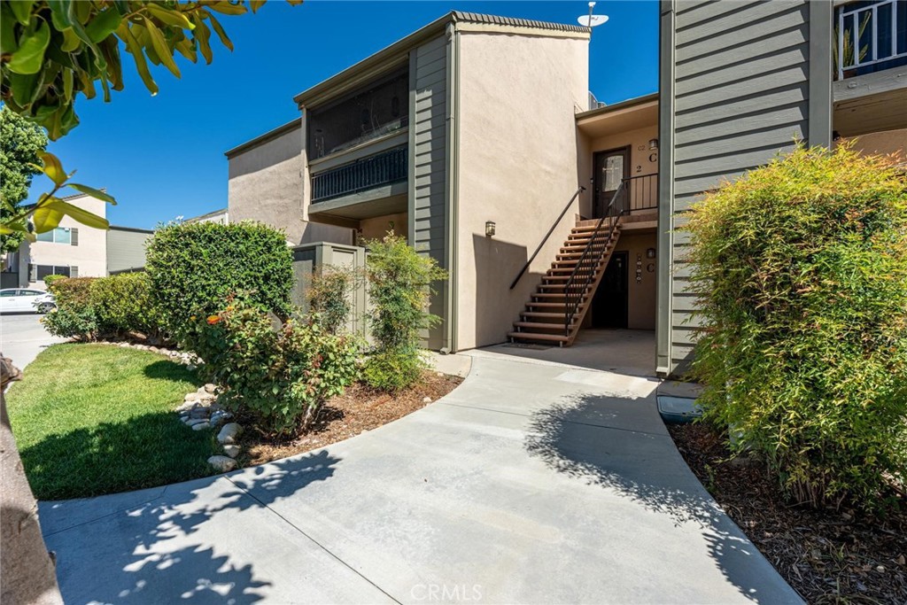 Welcome to this beautifully updated upper-level Valencia condo offering 2 spacious bedrooms and 2 full bathrooms in a tranquil, well-maintained community. The renovated kitchen features sleek quartz countertops, updated cabinetry, and stainless steel appliances. Enjoy entertaining with a built-in bar area with custom cabinets and lighting. This home has the ideal open-concept layout enhanced by luxury vinyl flooring, updated windows, recessed lighting, elegant crown molding and INDOOR laundry. Relax on your private balcony and take in the views of the lush Lakeshore grounds. The community offers a large pool and spa area, tennis and pickleball courts, basketball court, playground, and a serene lake. Plus, you are steps away from Vista Valencia Golf Course! 1 assigned carport spot and plenty of street parking near unit. With easy freeway access and just minutes to local shopping, dining, and entertainment, this home combines comfort, convenience, and community living at its finest.