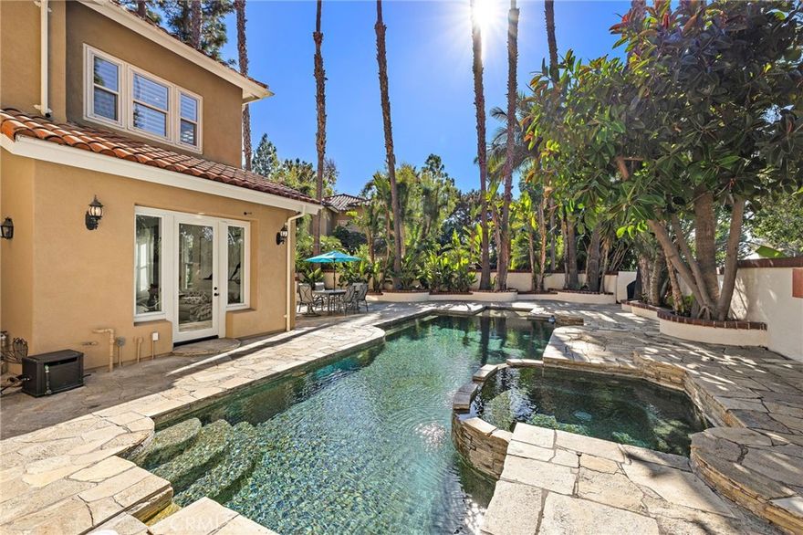 RARE Tropical POOL House with SPA in Gated community! Located on a PREMIUM Large Lot and features a Resort-style PebbleTec Pool and ample space for BBQ and entertaining—perfect for large gatherings. Lush tropical landscaping with Palms and Bird of Paradise ensures Privacy, Home is ideally located next to Tustin Ranch Golf Club, perfect for golf enthusiasts. Inside, enjoy Sun-filled spaces with High Vaulted Ceiling and Skylights. Designer upgraded and Spacious Gourmet Kitchen showcases floor-to-ceiling cabinetry with Quartz countertops. Throughout the home, Upgraded Flooring adds a modern and cohesive touch. Primary Suite offers a Spa-inspired bath with a Jacuzzi tub, while Custom Built-in Closets provide organized storage for clothing, bags, and accessories. Secondary bedrooms share an upgraded Jack-and-Jill bath with a luxury custom-tiled shower and European-style fixtures. Residents enjoy Tustin Ranch HOA amenities, featuring Gallery Park, pool/spa, tennis courts, playground, and more. BEST LOCATION! The home is zoned to award-winning schools including Beckman High, and offers convenient access to premier shopping at Tustin Marketplace and The District, Sports Park, and 5 Freeway.