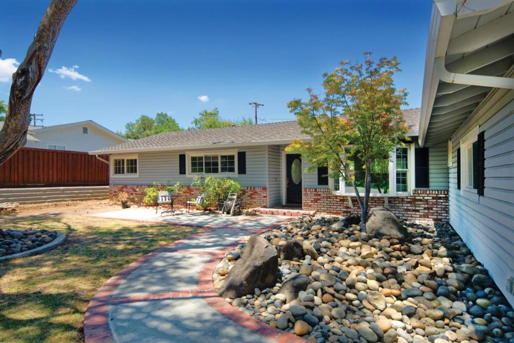 Welcome to this charming Almaden Country Club gem, where classic curb appeal meets modern elegance. This beautifully updated single-level home offers four spacious bedrooms and two luxurious bathrooms across nearly 2,000 square feet of light-filled living space. Step inside to discover rich hardwood floors, soaring vaulted ceilings, and designer lighting throughout. The chefs kitchen is a true showstopper, featuring sleek quartz countertops, high-gloss cabinetry, stainless steel appliances, and a sunlit skylight. The inviting family room with a stylish fireplace opens to a backyard retreat complete with a large patio, Bocce Ball court, fruit trees, and ambient lightingperfect for relaxing or entertaining under the stars. With dual-pane windows, central A/C, and a finished garage with built-ins and a loft, this home is thoughtfully designed for comfort, style, and function. Plus, a transferable Almaden Swim & Racquet Club membership adds incredible lifestyle value!