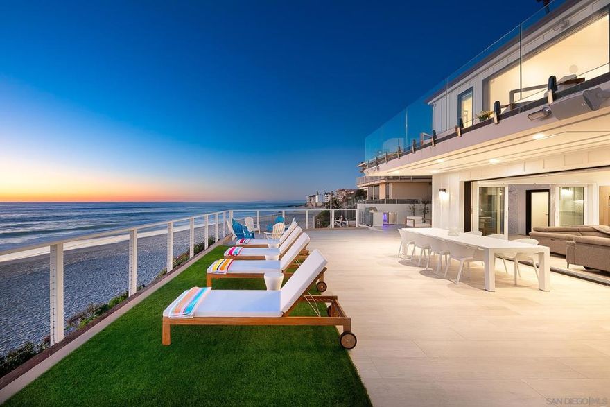 INCREDIBLE OPPORTUNITY ON THE BEACH! Welcome to 303 Sea Lane, an extraordinary oceanfront residence set directly on the coveted sands of Marine Street Beach—one of La Jolla’s most exclusive and picturesque stretches of coastline. This is more than a home; it’s a once-in-a-generation opportunity to own a true legacy property in one of Southern California’s most prestigious coastal enclaves. Completely reimagined in 2023 from the ground up, this .38-acre modern masterpiece blends timeless luxury with cutting-edge design. With 5 bedrooms, 5 baths, and 4194 square feet of refined living space across two levels, this home was built for seamless indoor-outdoor living and unforgettable entertaining. From the moment you enter, you’re greeted by sweeping whitewater views and the calming sound of crashing waves. Every detail has been thoughtfully curated—from sleek porcelain tile flooring and aluminum-clad doors and windows, to the state-of-the-art RTI Smart Home system, complete with whole-home surround sound controlled by your phone or tablet. The residence features two full chef’s kitchens, each with striking glossy grey cabinetry, quartzite counters, and high-end appliances—ideal for multigenerational living or elevated hosting. Upstairs, the primary suite is a tranquil retreat with panoramic ocean views, a spa-inspired bath with Brizo fixtures and Porcelanosa tile, and a generous walk-in closet. Start your mornings with toes in the sand and end your days with golden-hour sunsets from your private balcony.  Step outside to expansive outdoor living spaces: a BBQ island, tiled patio, fenced yard, and outdoor shower—perfect for rinsing off after a surf session or barefoot beach stroll. Additional highlights include a 2-car garage, a high-end video security system, and a spacious laundry room with ample storage. This is coastal living at its finest—a trophy property offering privacy, prestige, and an unbeatable lifestyle literally on the beach. Properties like this rarely change hands. And with a newly adjusted price, it now represents one of the best values on the California coastline. Thngs you will absolutely love about this property: - On-the-sand location - World-class views - Generational legacy home - Beautifully remodeled with high quality finishes - Priced to sell – an exceptional value in today’s market! Don’t miss your chance to claim this rare La Jolla beachfront gem. Schedule your private tour today.