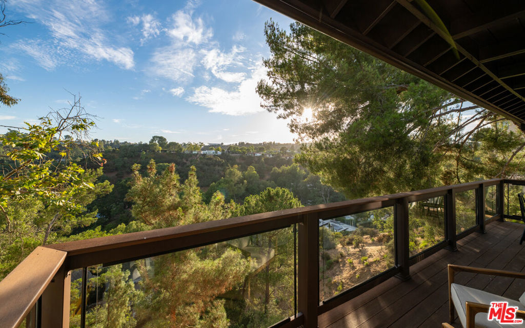 Tucked away at the end of a private cul-de-sac in Laurel Canyon, this 3-bedroom, 2-bath retreat feels like a world apart. Here, the city fades away and every evening ends with golden sunsets spilling across the hills. The west-facing views are nothing short of spectacular, offering a daily reminder of why people dream of California living.Inside, a remodeled kitchen opens to light-filled living spaces that flow effortlessly outdoors. Upstairs, a comfortable living room opens to a balcony that hovers above the treetops, while two tranquil bedrooms capture the serenity of the canyon.Downstairs, the primary suite anchors the home with a generous bedroom, spacious bath, and a large living area that opens directly to the expansive deck. It's a seamless extension of the indoor-outdoor lifestyle, where you can relax, entertain, or simply take in the sweeping canyon sunsets in complete privacy.Perfect for families, creatives, or anyone seeking both privacy and inspiration, this home blends nature, space, and modern comfort in one unforgettable setting. With the Wonderland School District at your doorstep and breathtaking sunsets as your backdrop, this is Laurel Canyon living at its absolute best.